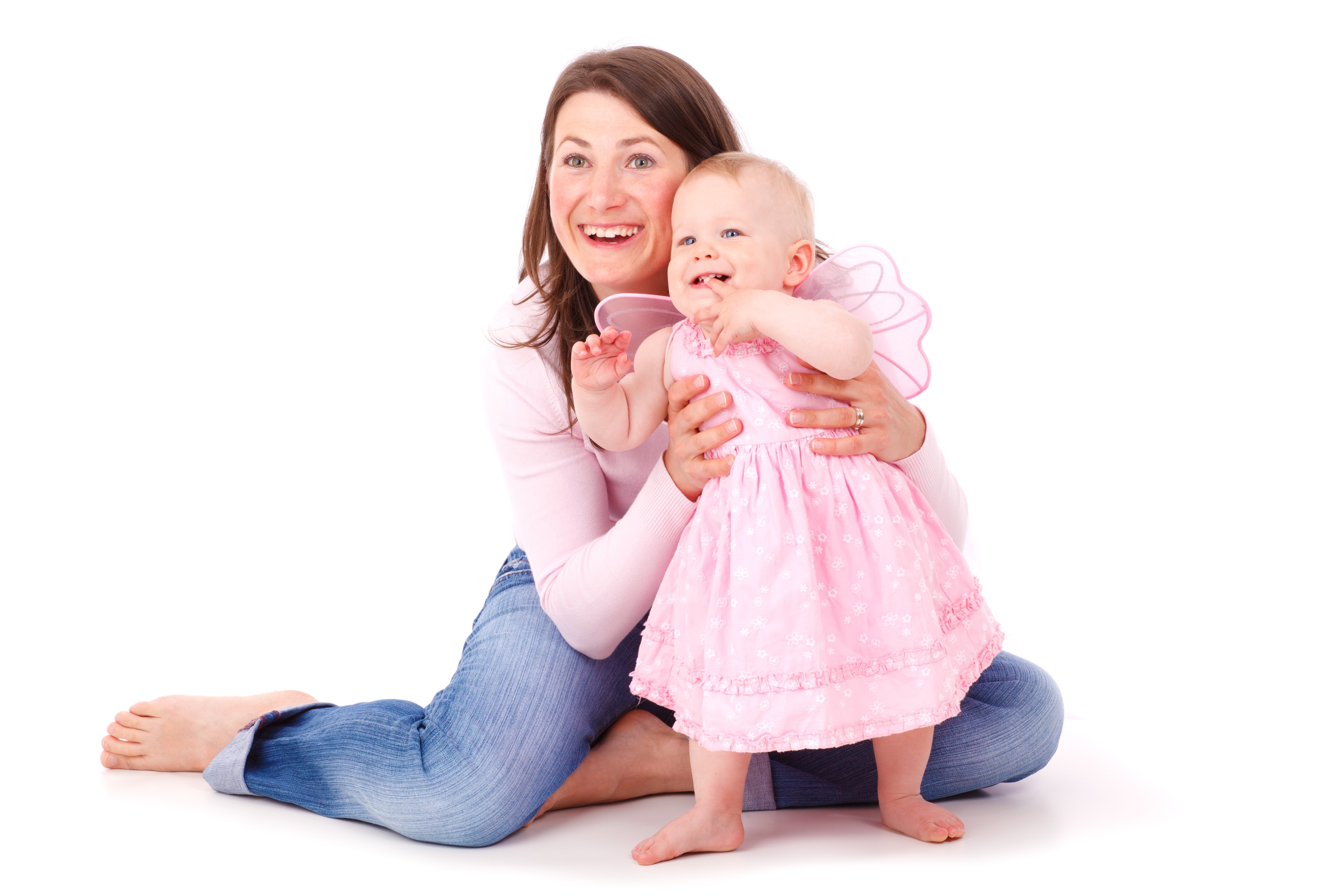 Woman holding the waist of baby girl in pink dress photo