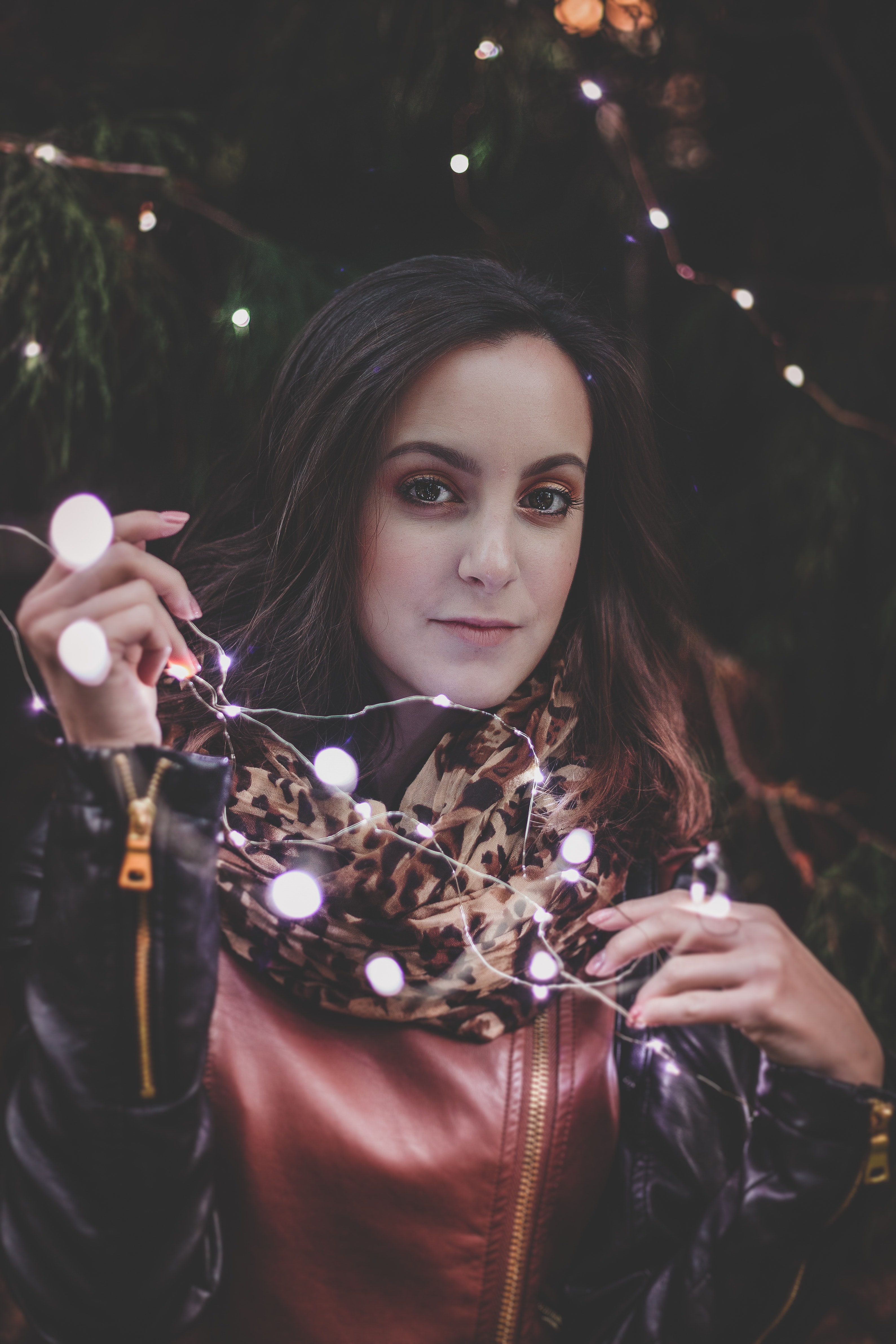 Woman holding white string lights photo