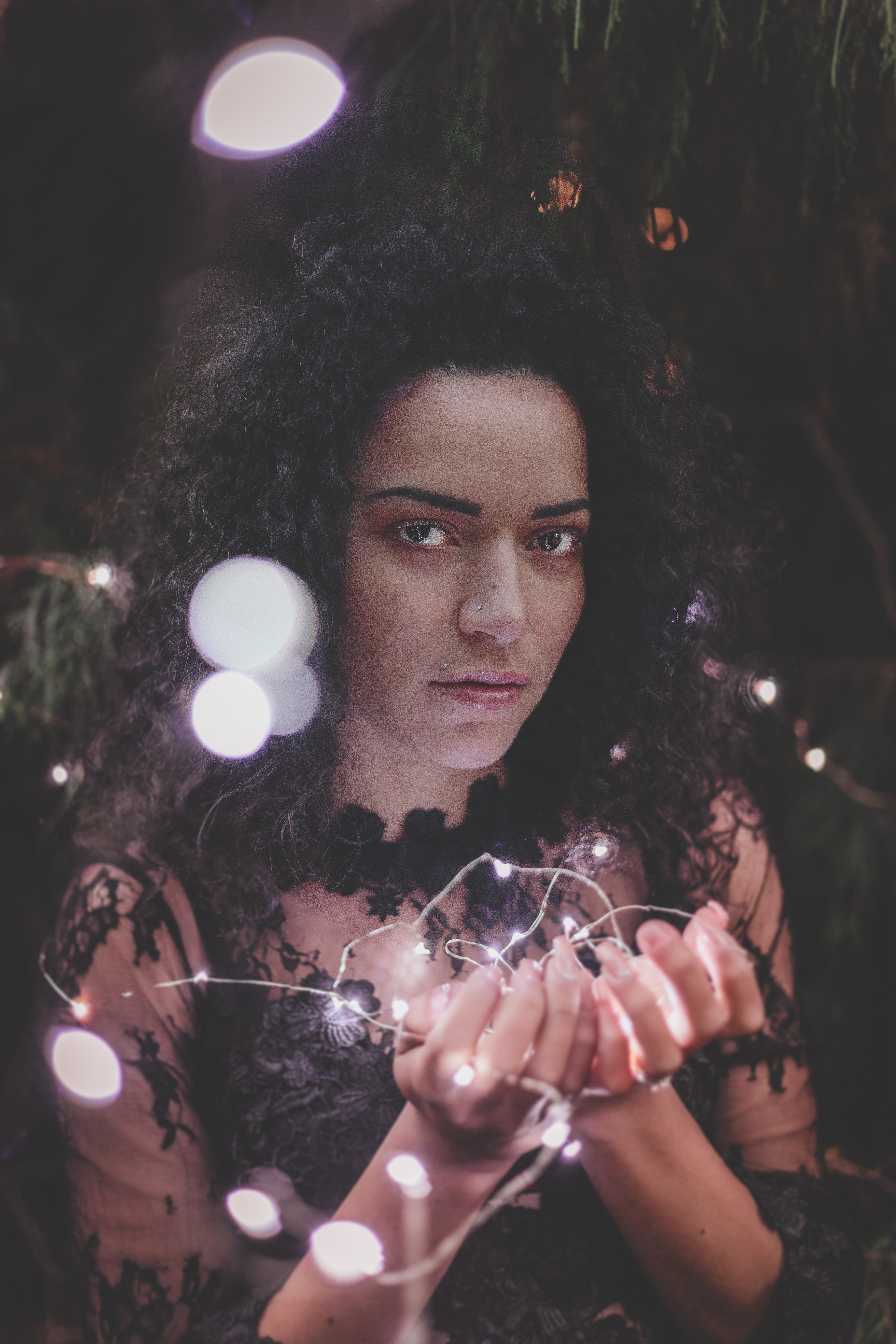 Woman holding white string lights photo