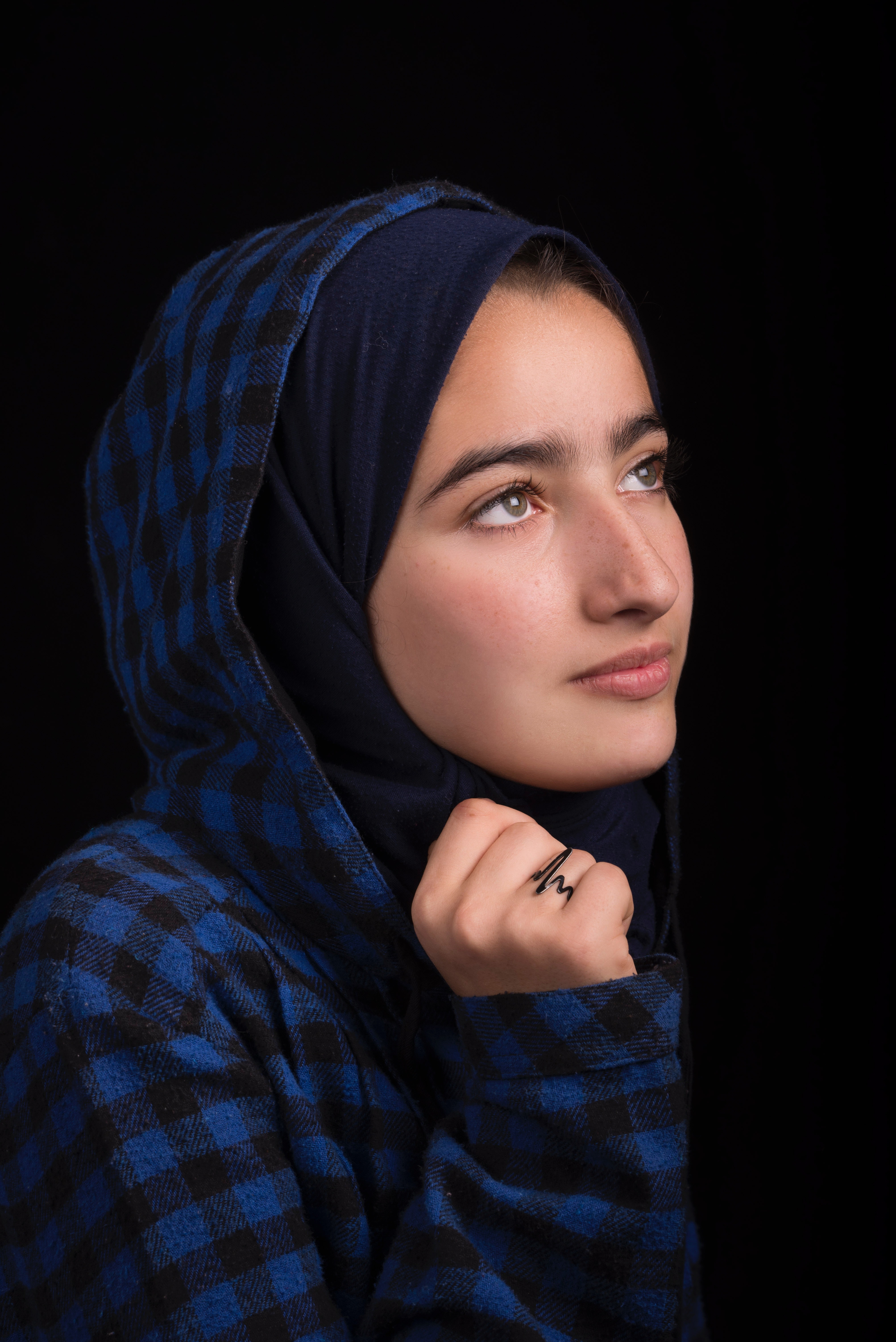 Woman in black and blue plaid headscarf photo