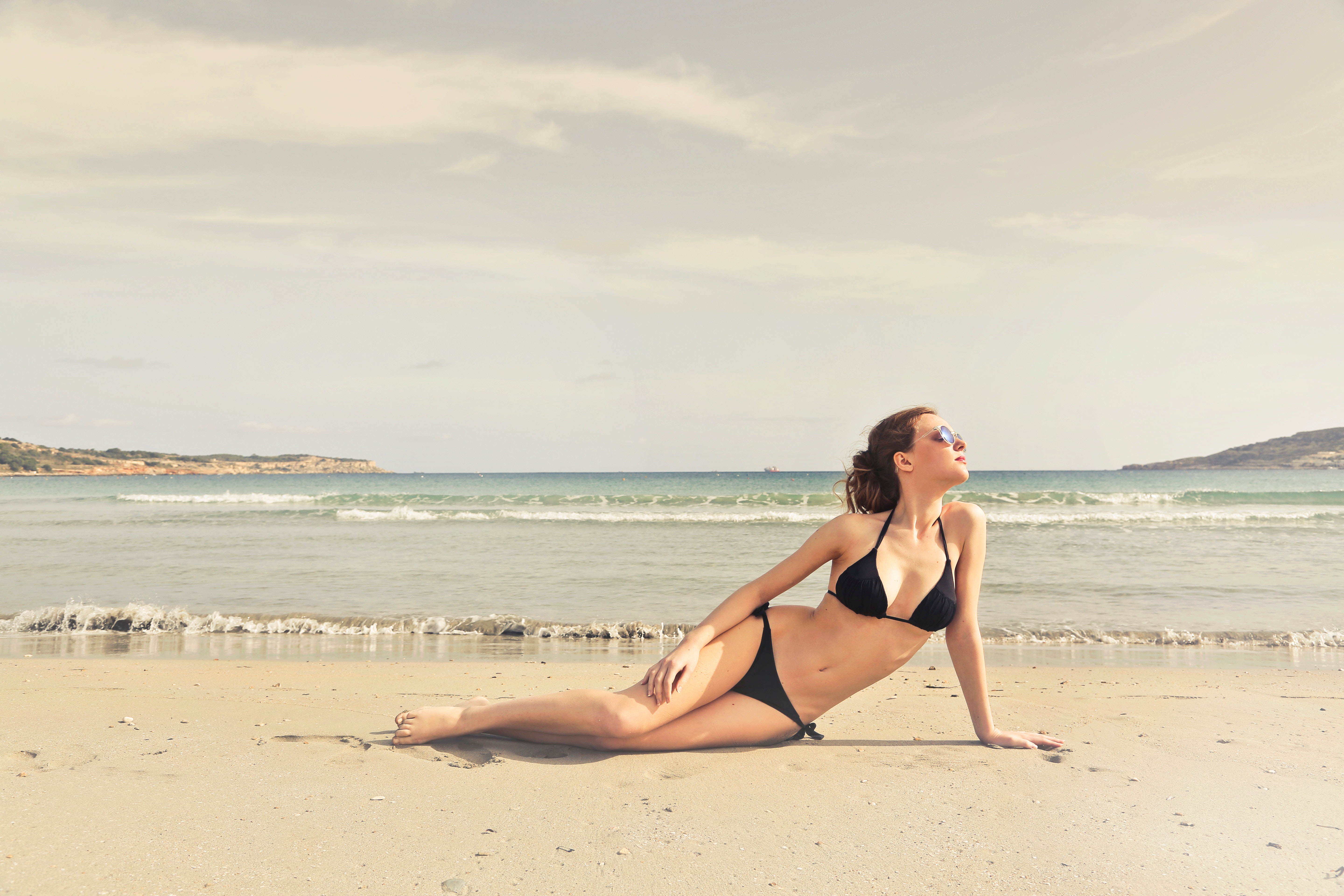 Woman in black bikini on seashore photo