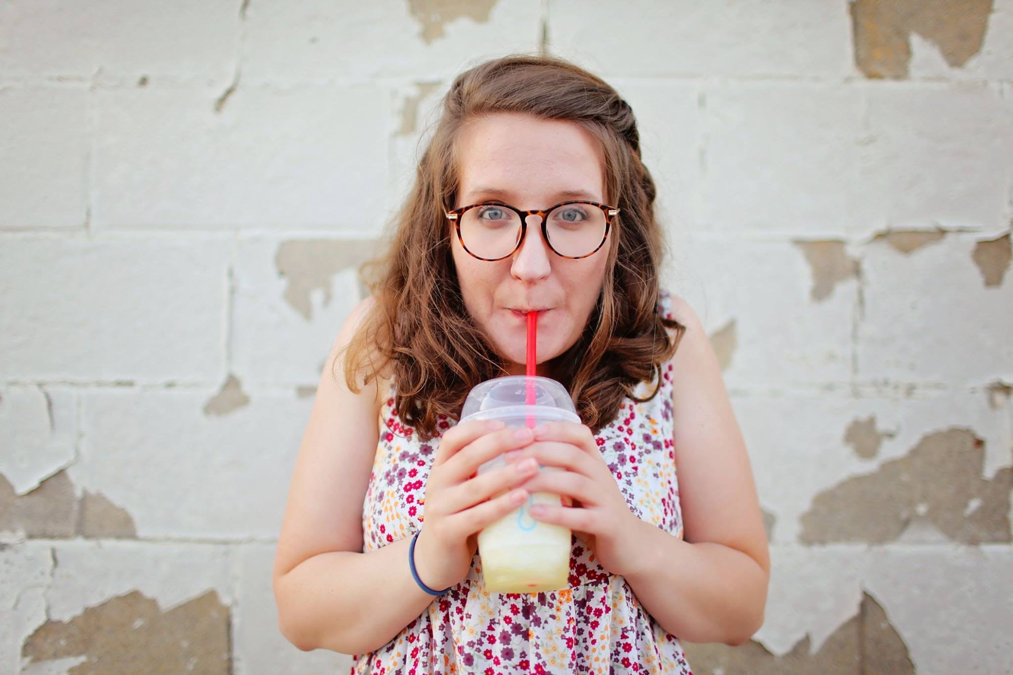 Woman in black framed eyeglasses drinking photo