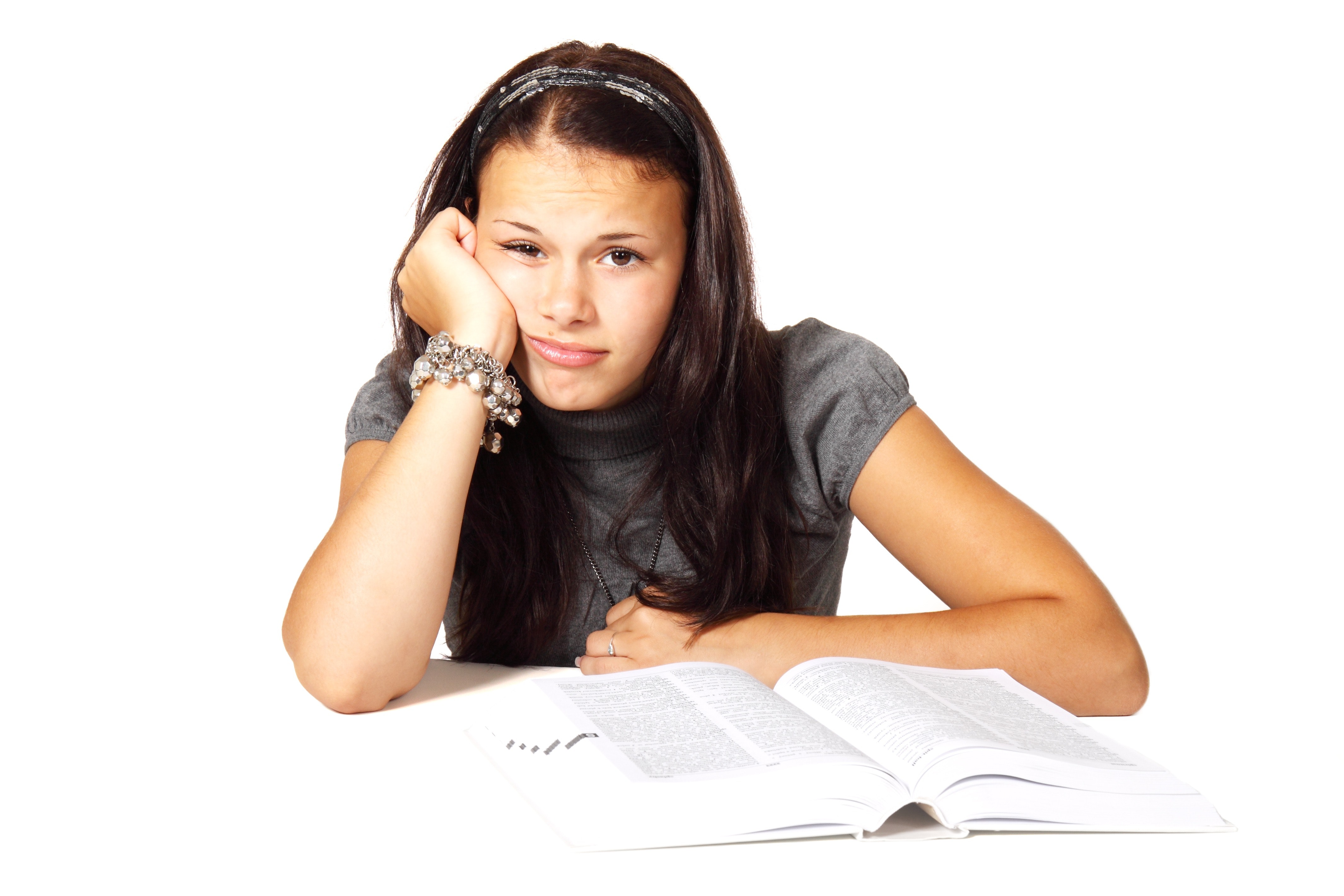 Woman in black t-shirt leaning on white table in front of white book photo