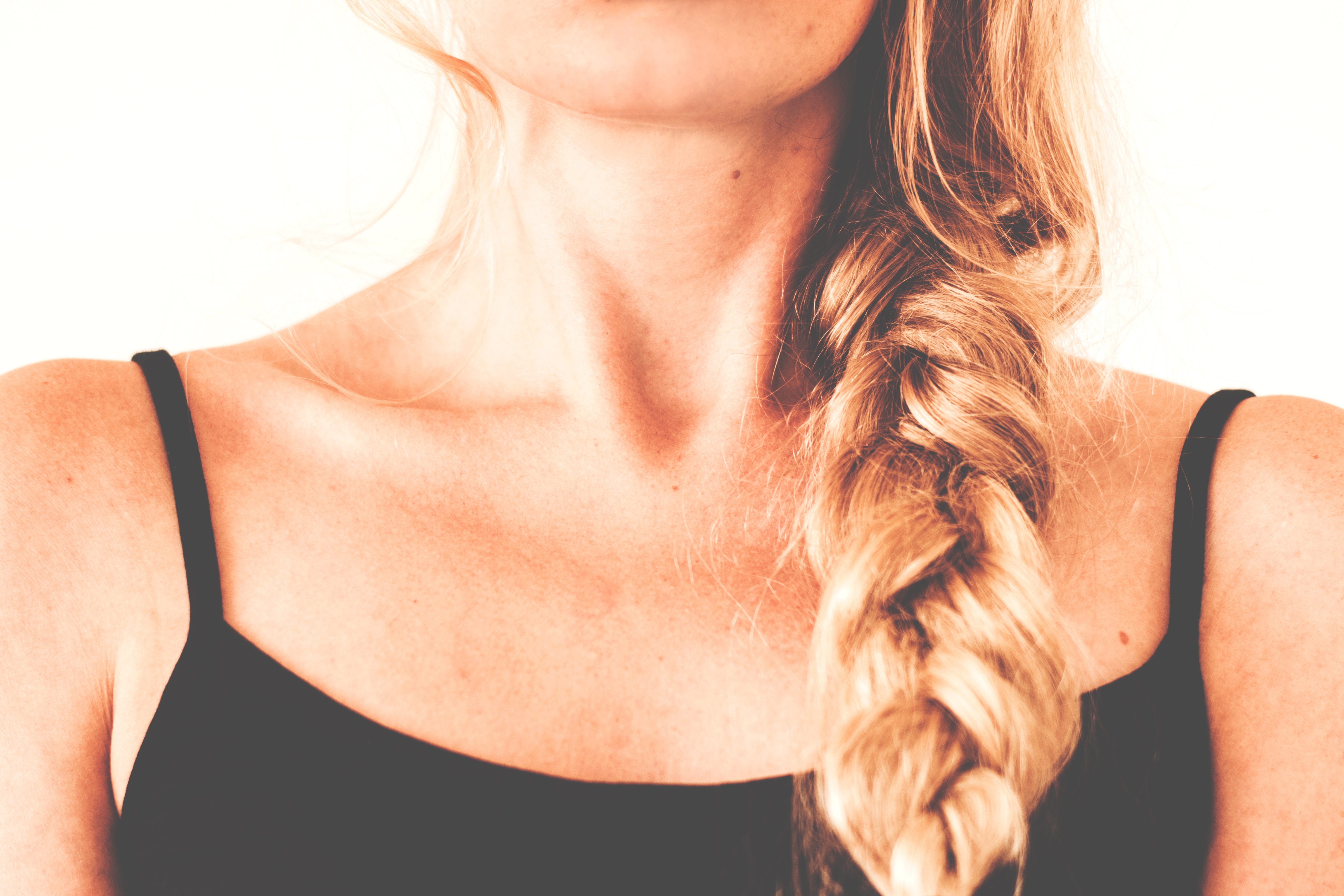 Woman in black tank top with braided hair photo