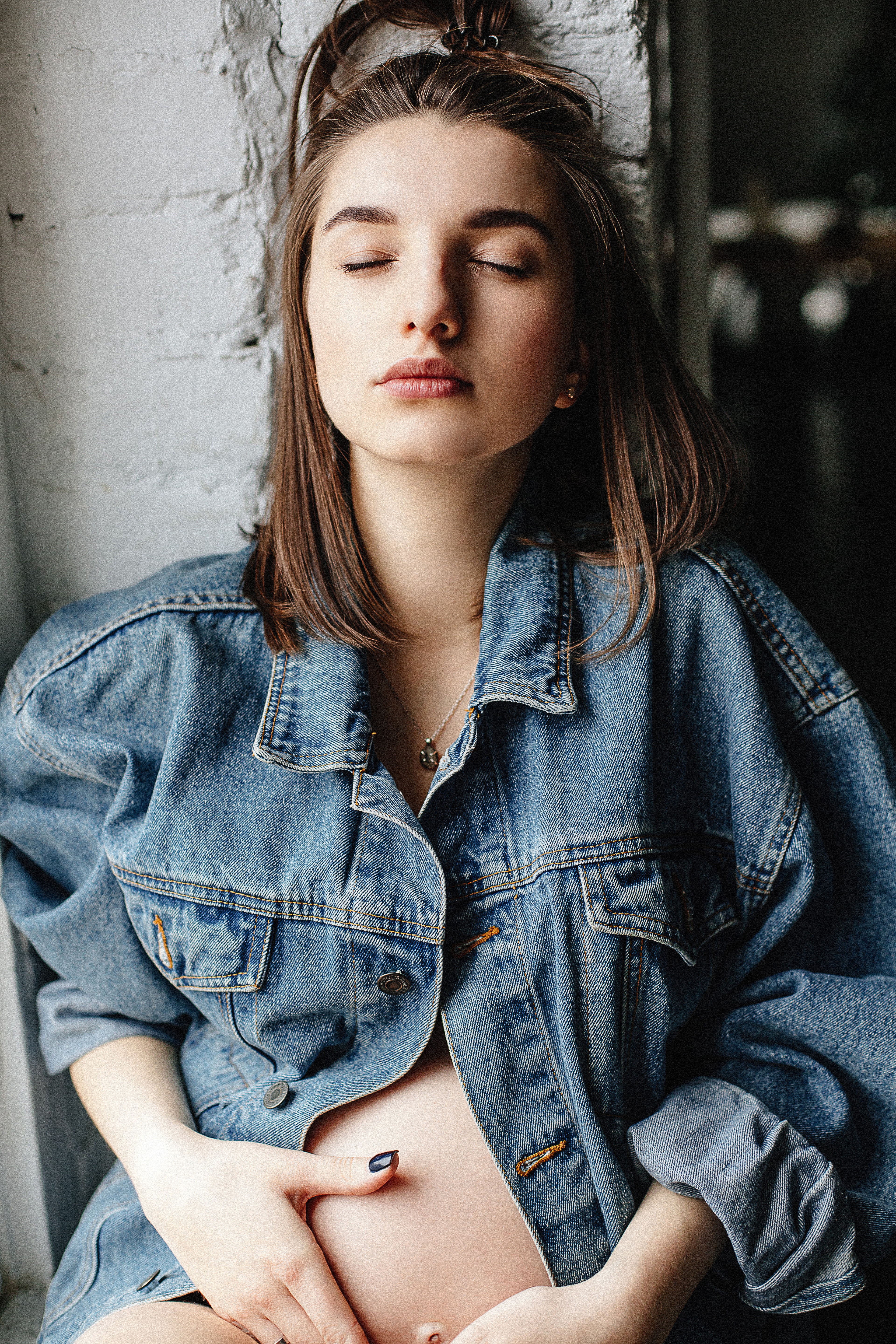 Woman in blue denim button-up jacket photo