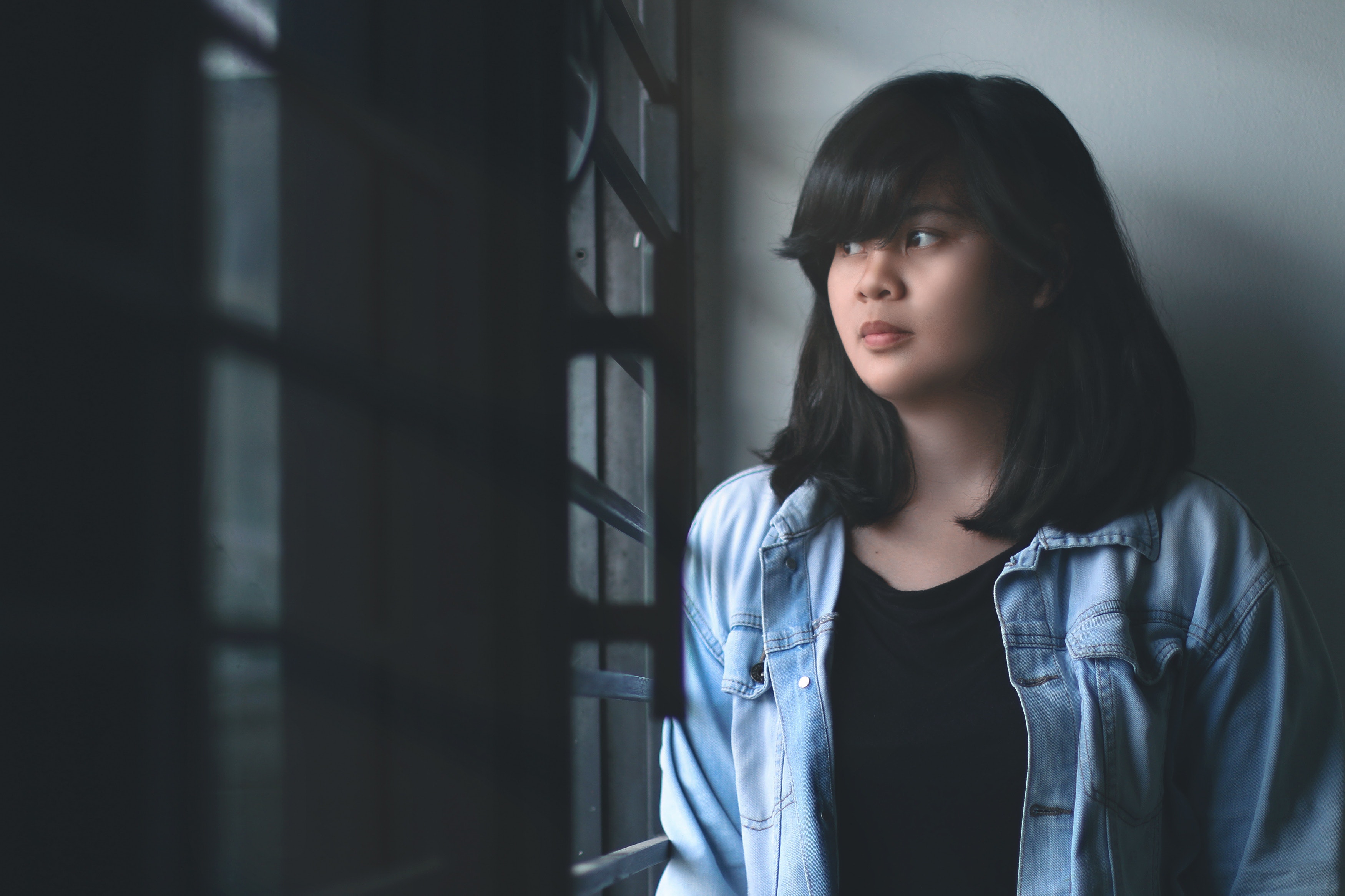 Woman in blue denim jacket indoors photo