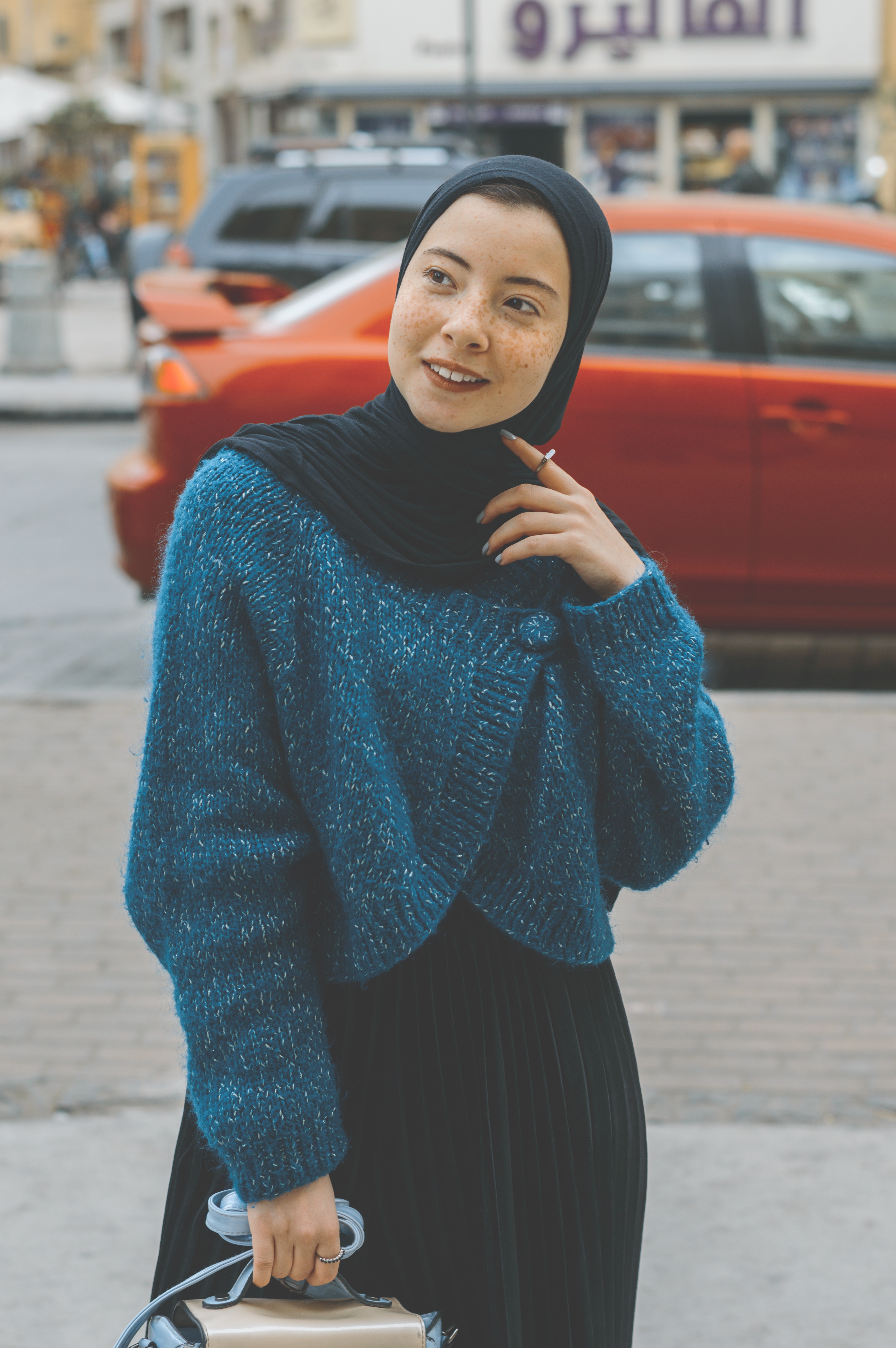 Woman in blue sweater with black hijab outfit photo