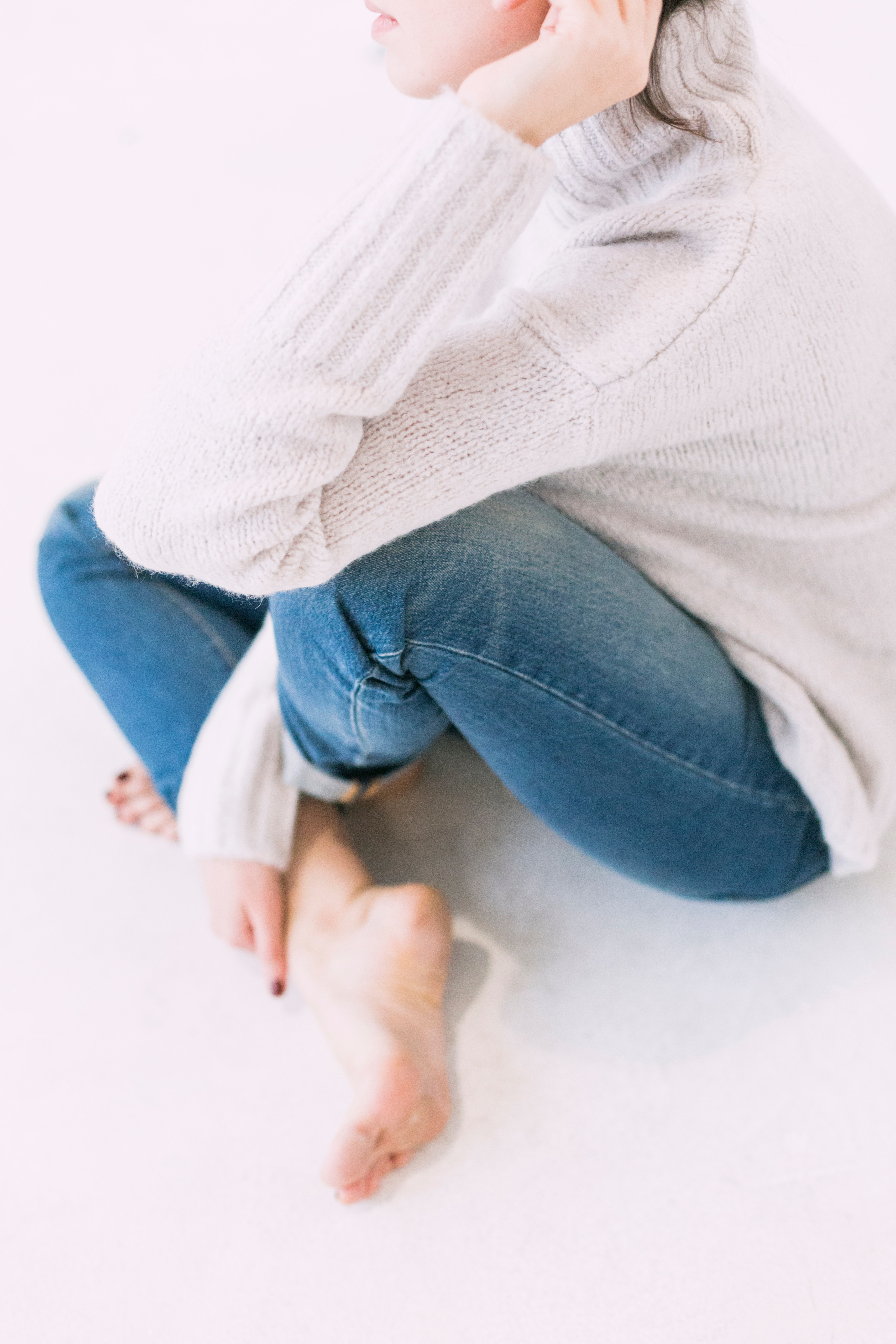 Woman in gray sweater and blue denim jeans photo