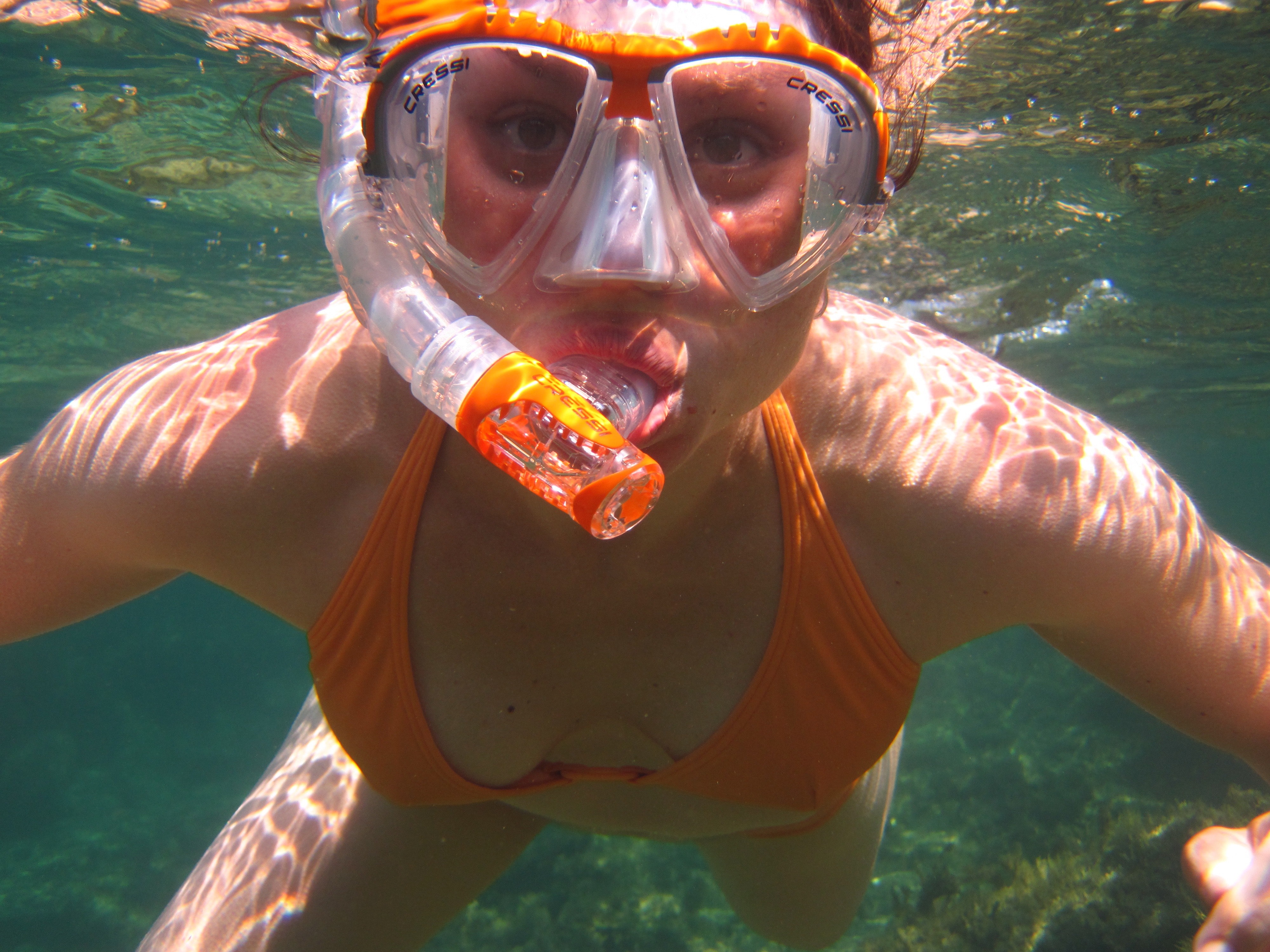 Woman in orange bikini underwater with snorkel photo