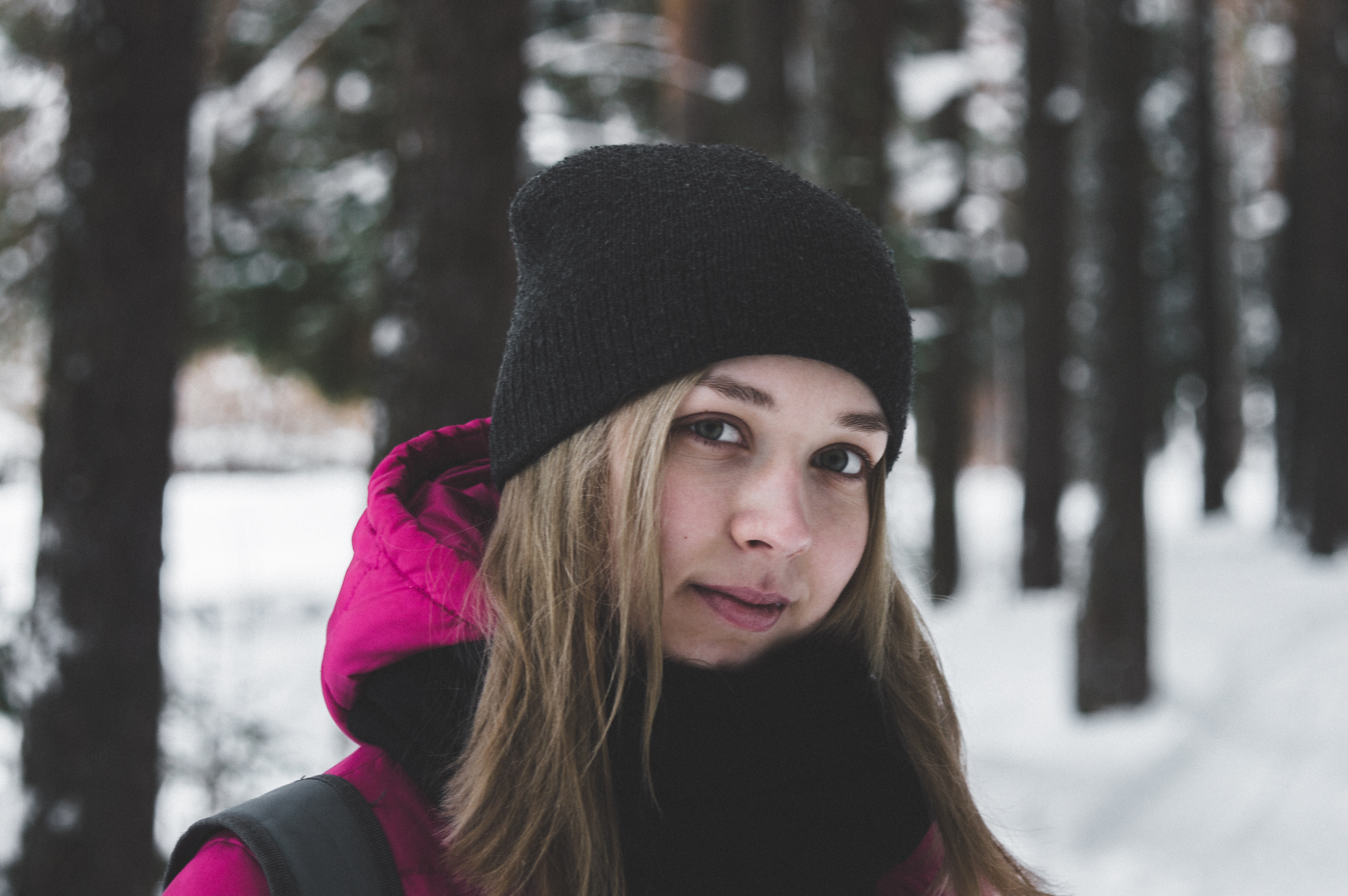 Woman in pink and black jacket on white snow photo