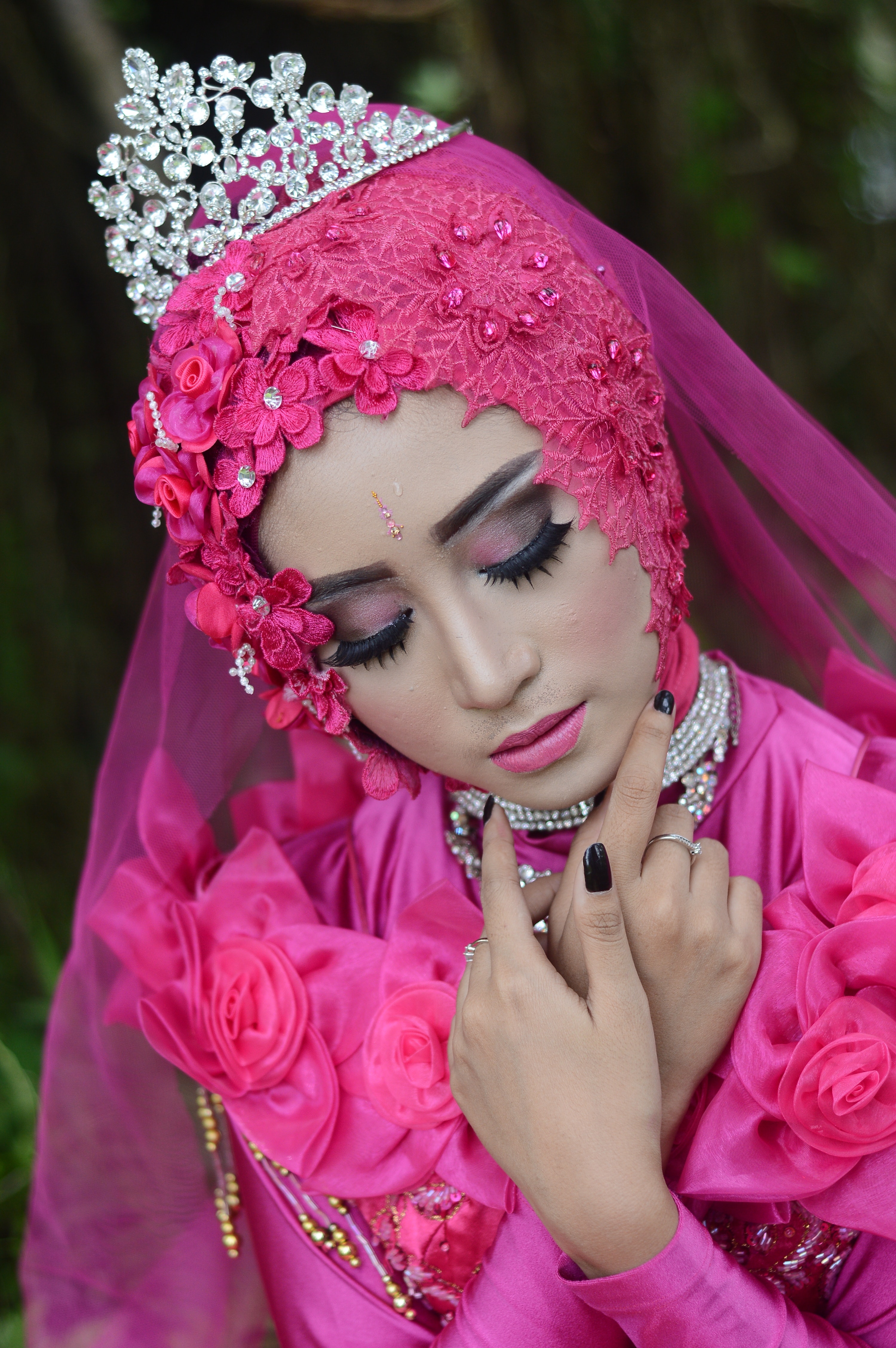 Woman in pink traditional dress wearing a tiara photo