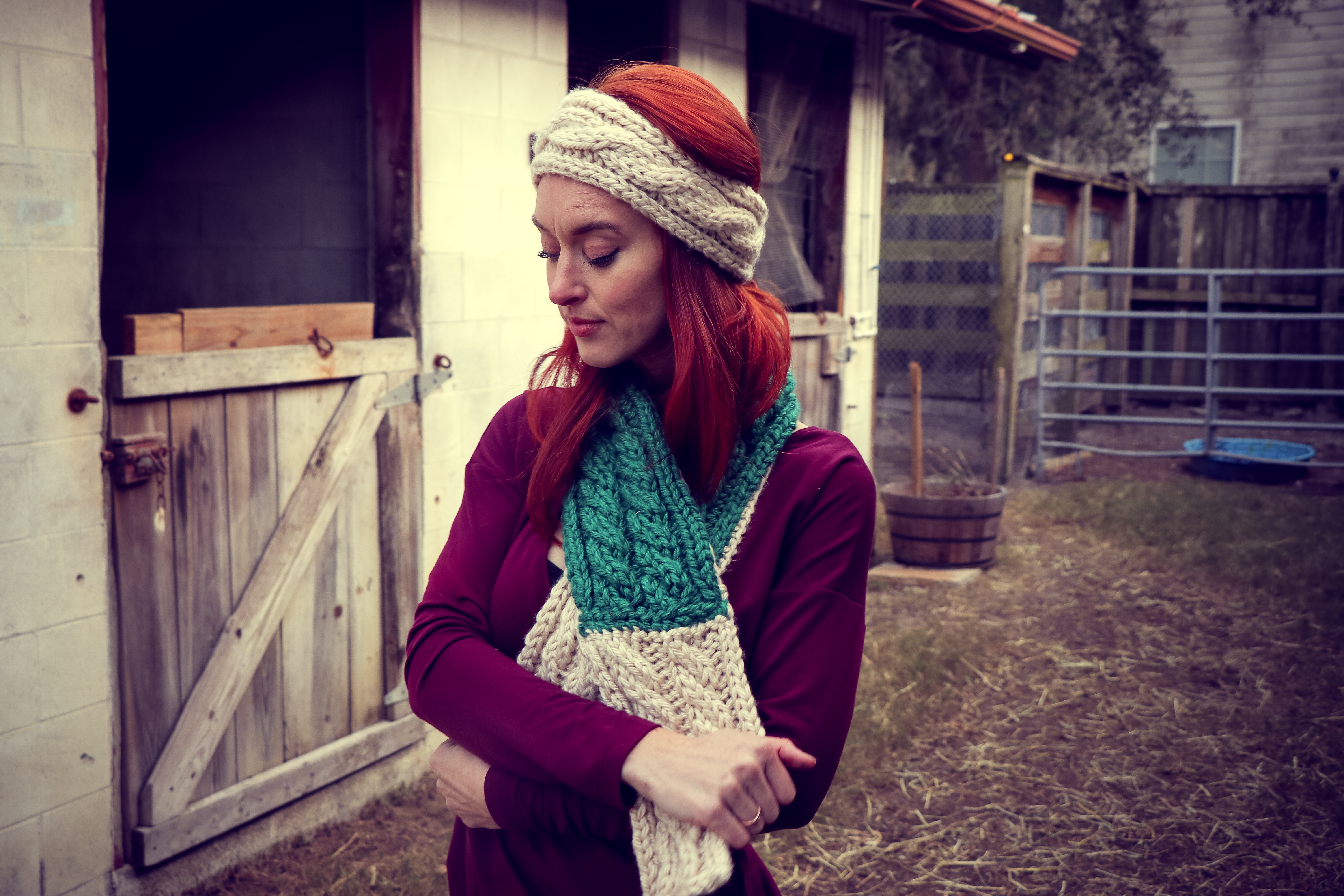 Woman in purple sweatshirt wearing knitted beanie and scarf photo