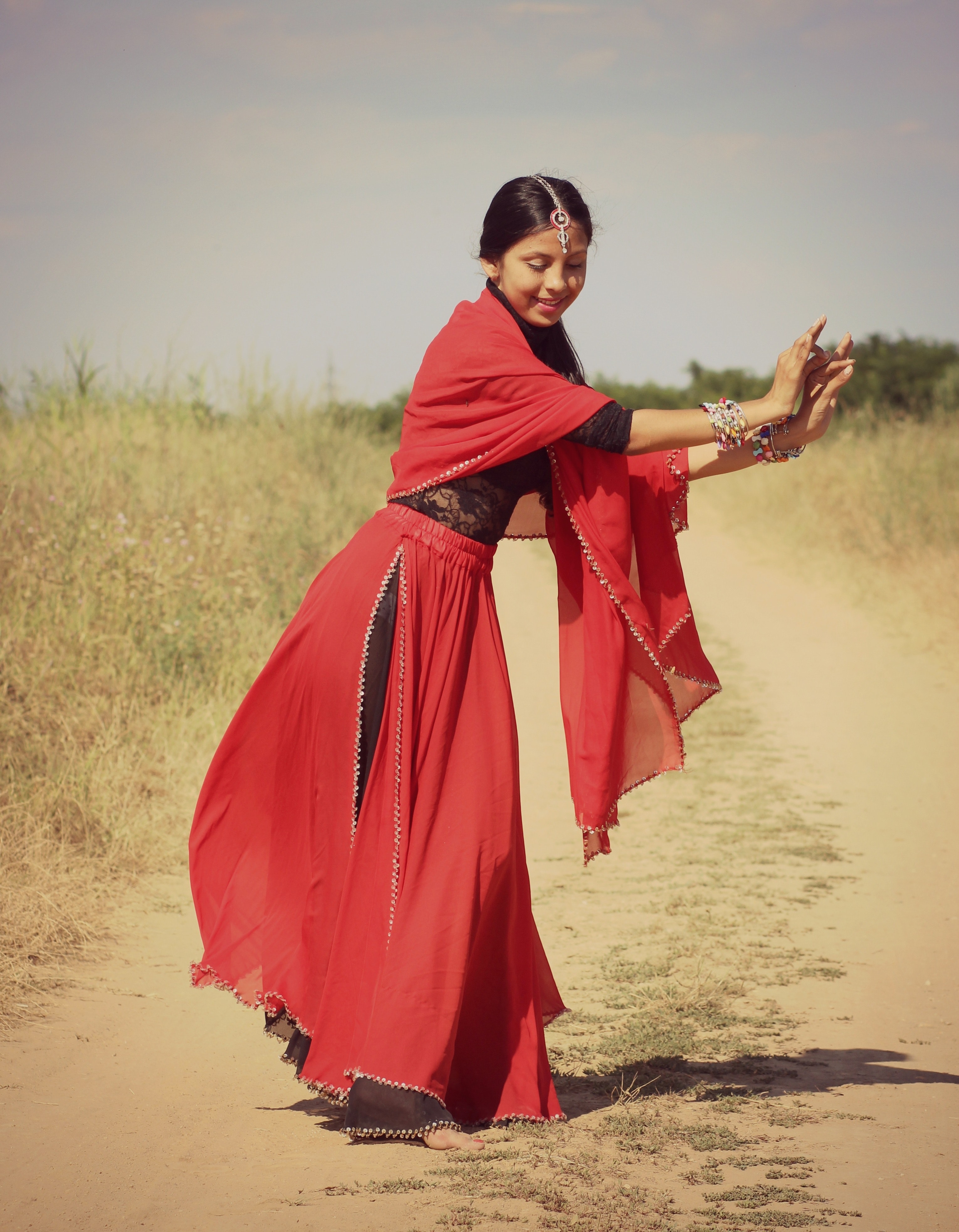 Woman in red and black 3/4 sleeve dress dancing photo