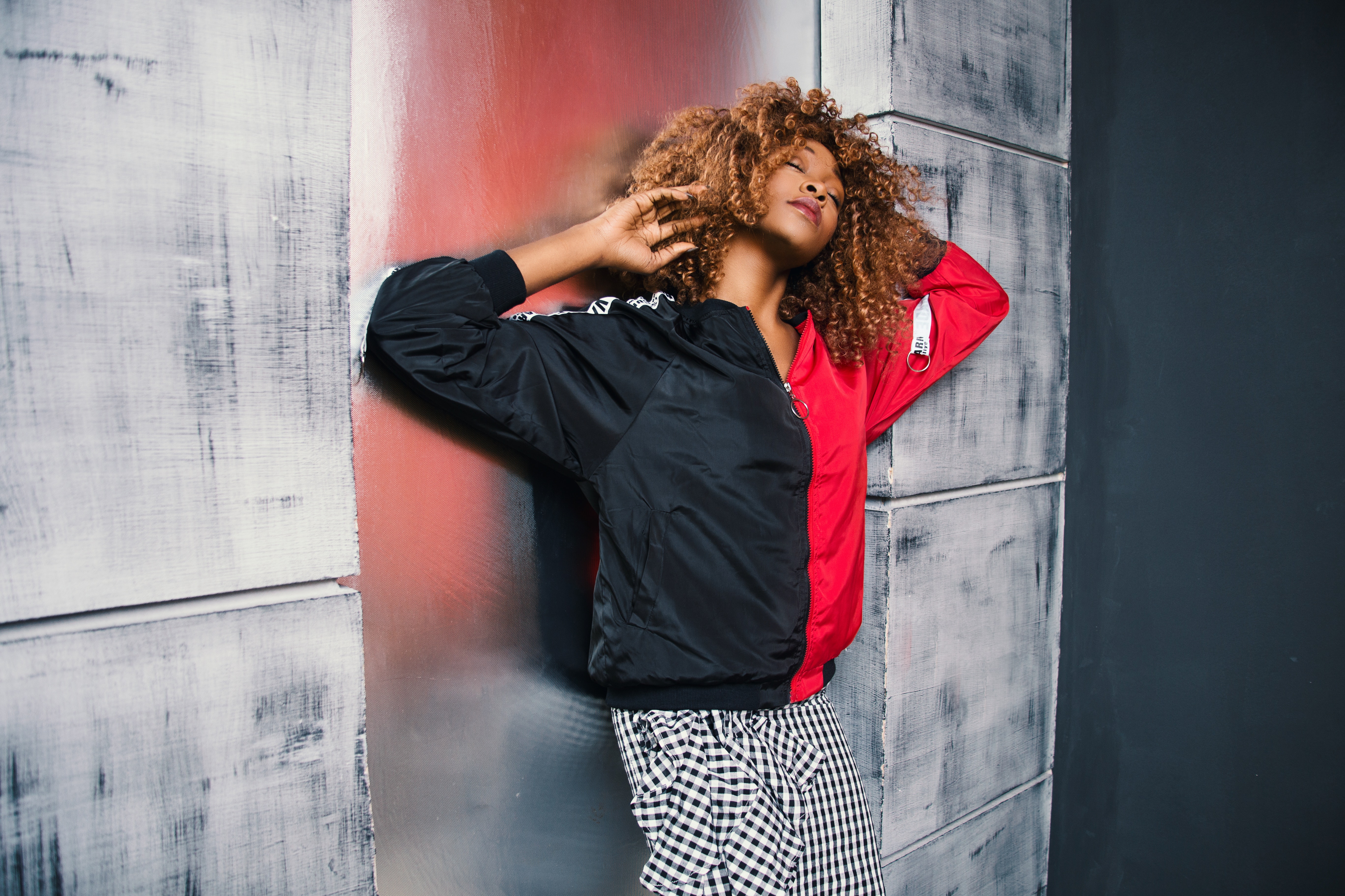 Woman in red and black bomber jacket photo