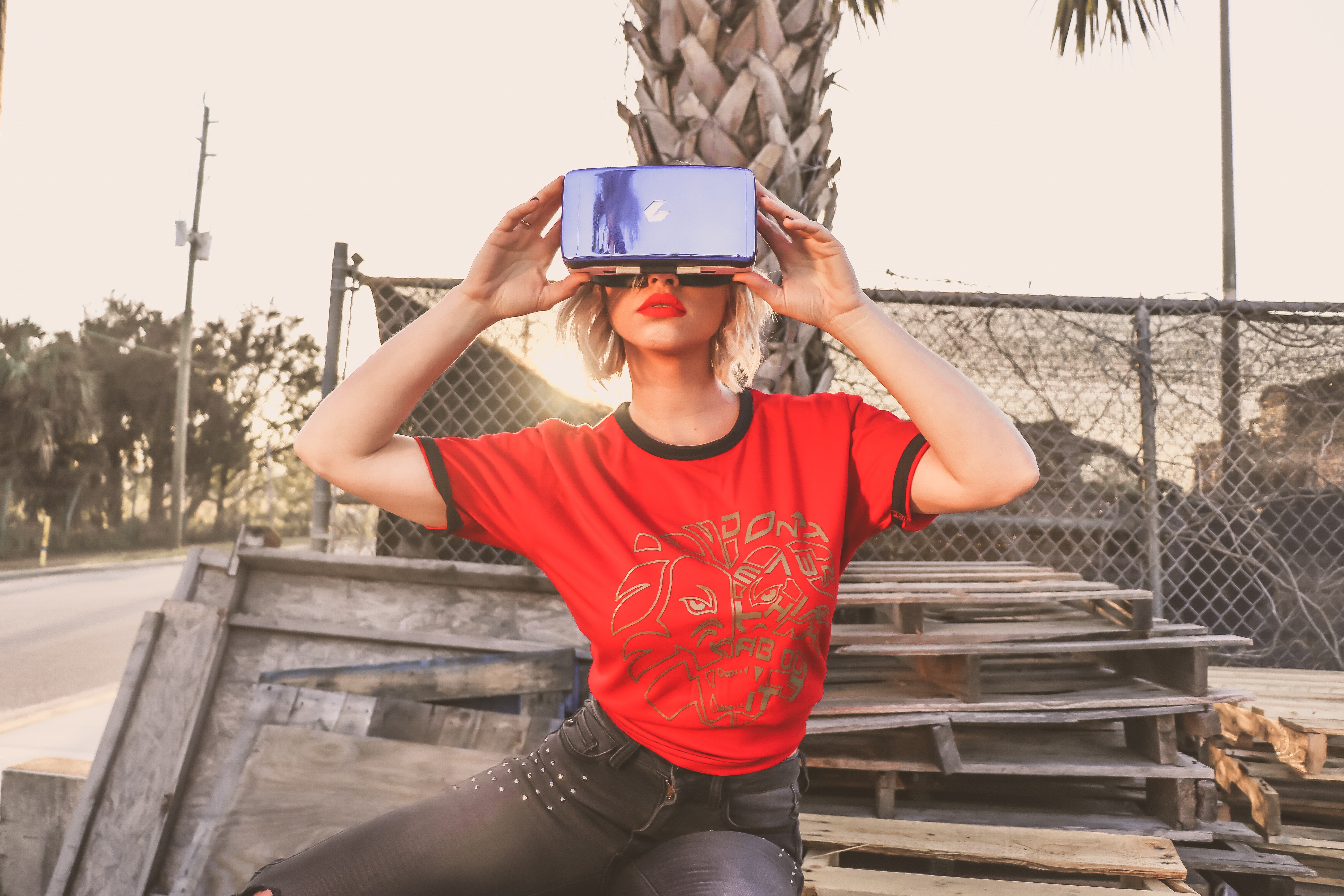 Woman in red crew-neck t-shirt wearing virtual reality glasses photo