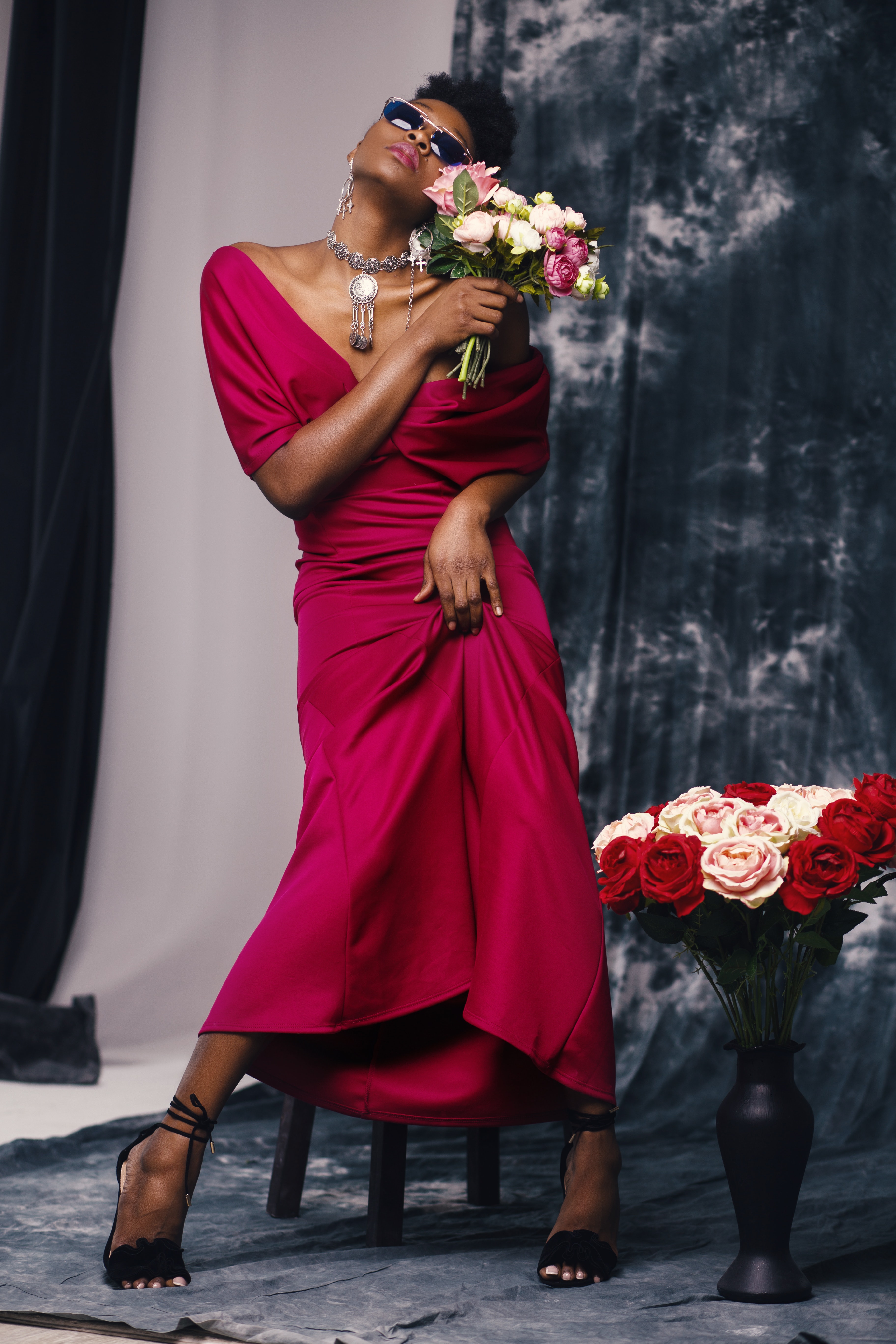 Woman in red dress holding flower photo