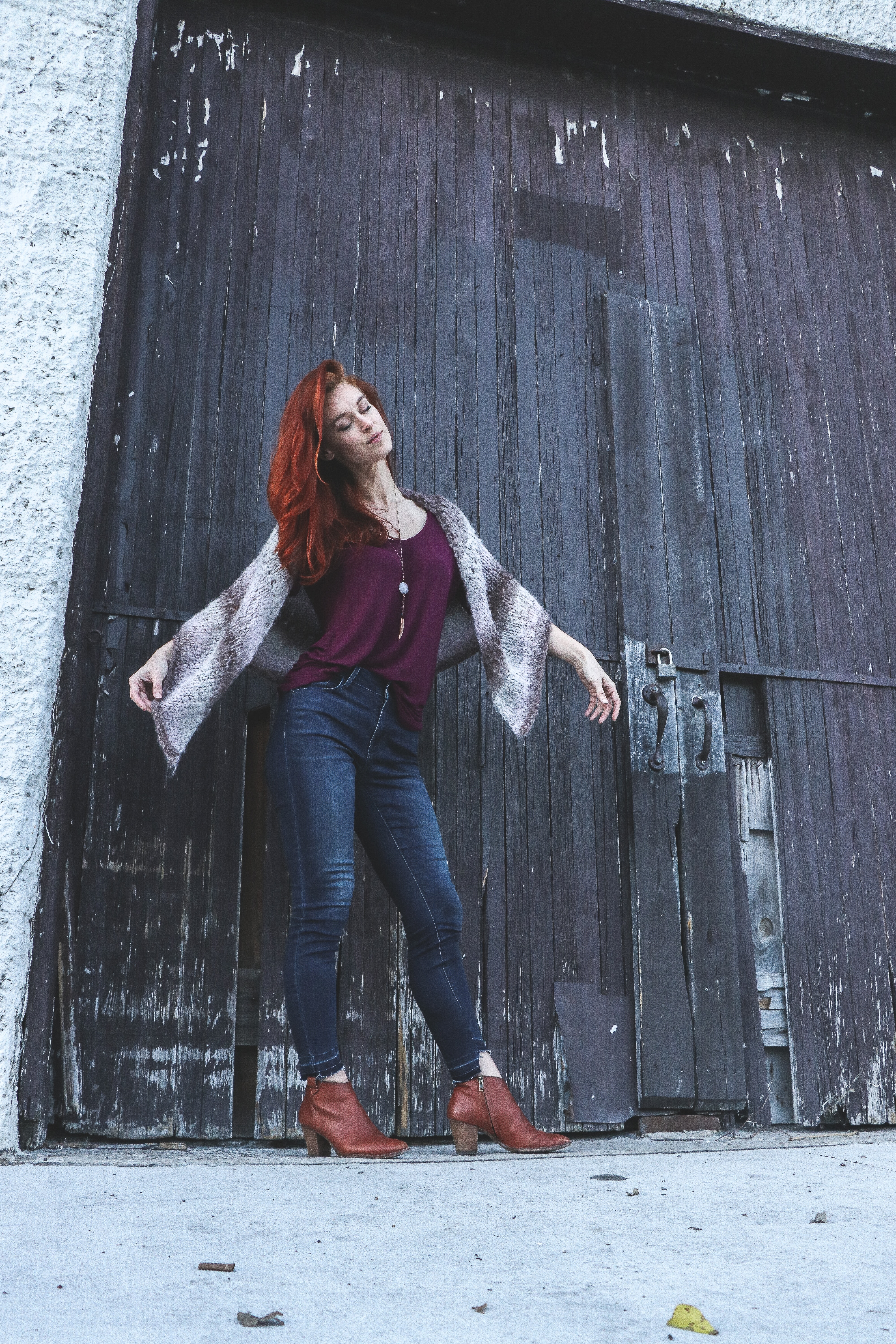 Woman in Red Tank Top With Brown Scarf Standing Near Black Wooden Door Closed, Adult, Red hair, Outdoors, Outfit, HQ Photo