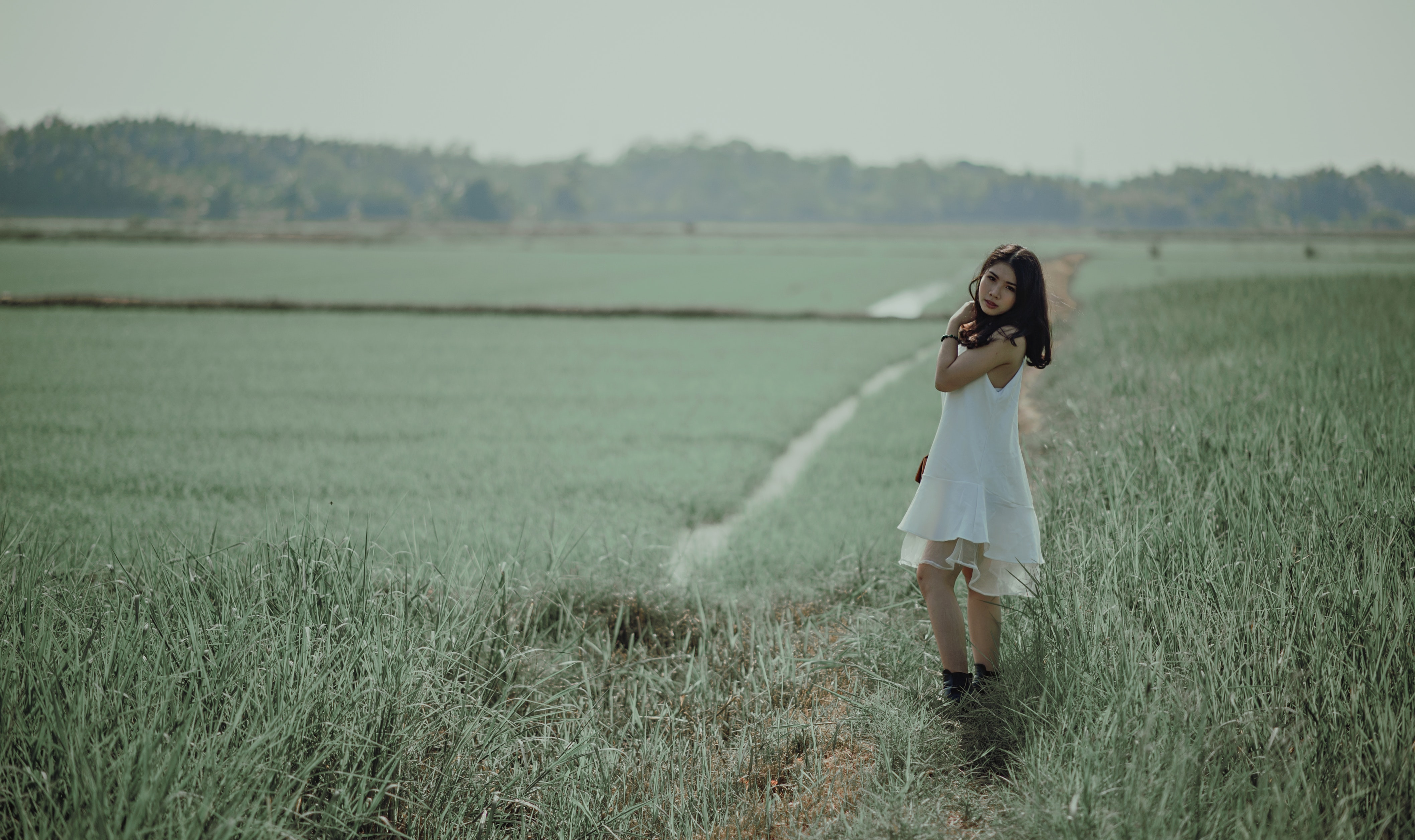 Woman in white sleeveless dress on grass field photo