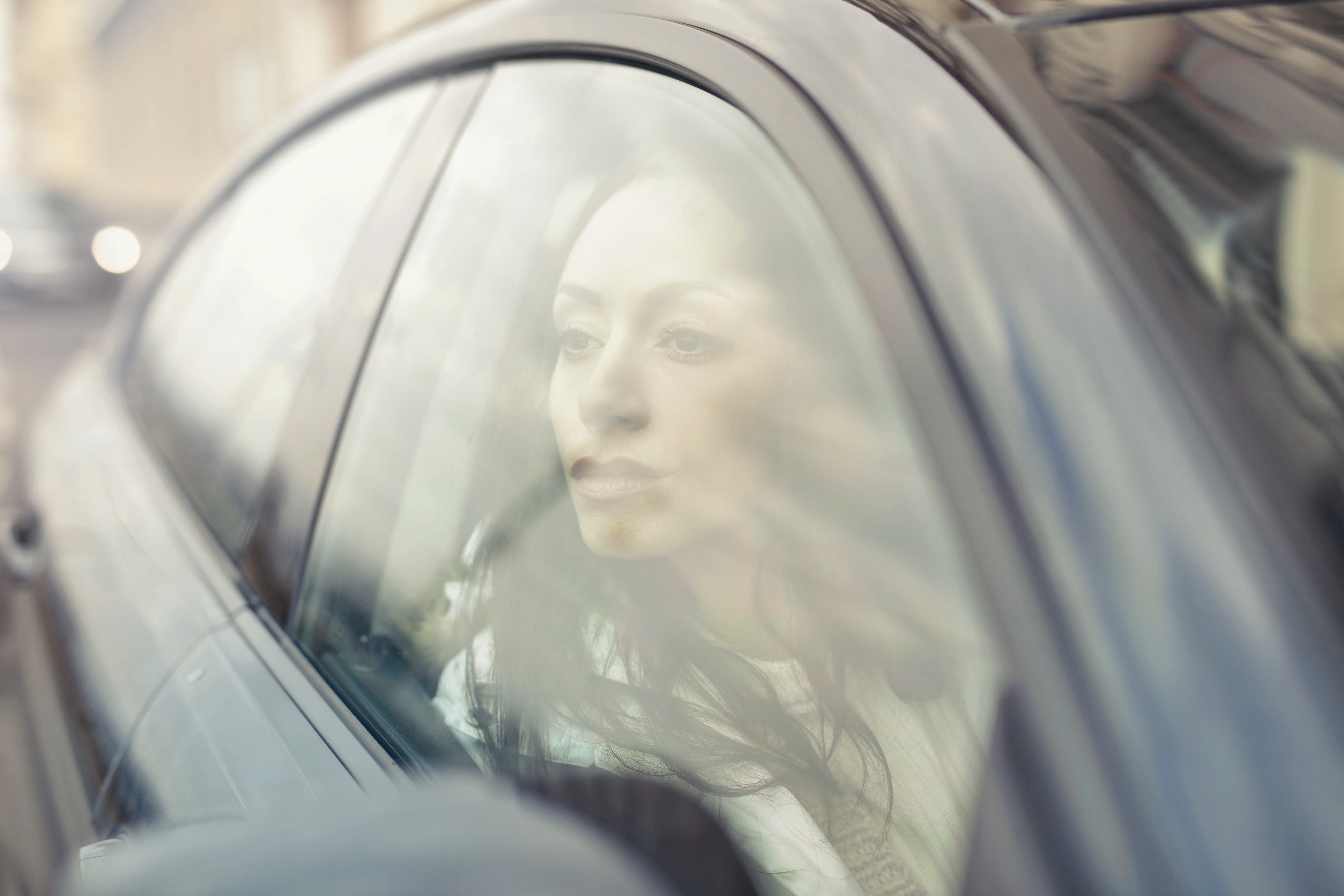 Woman inside the black sedan at daytime photo