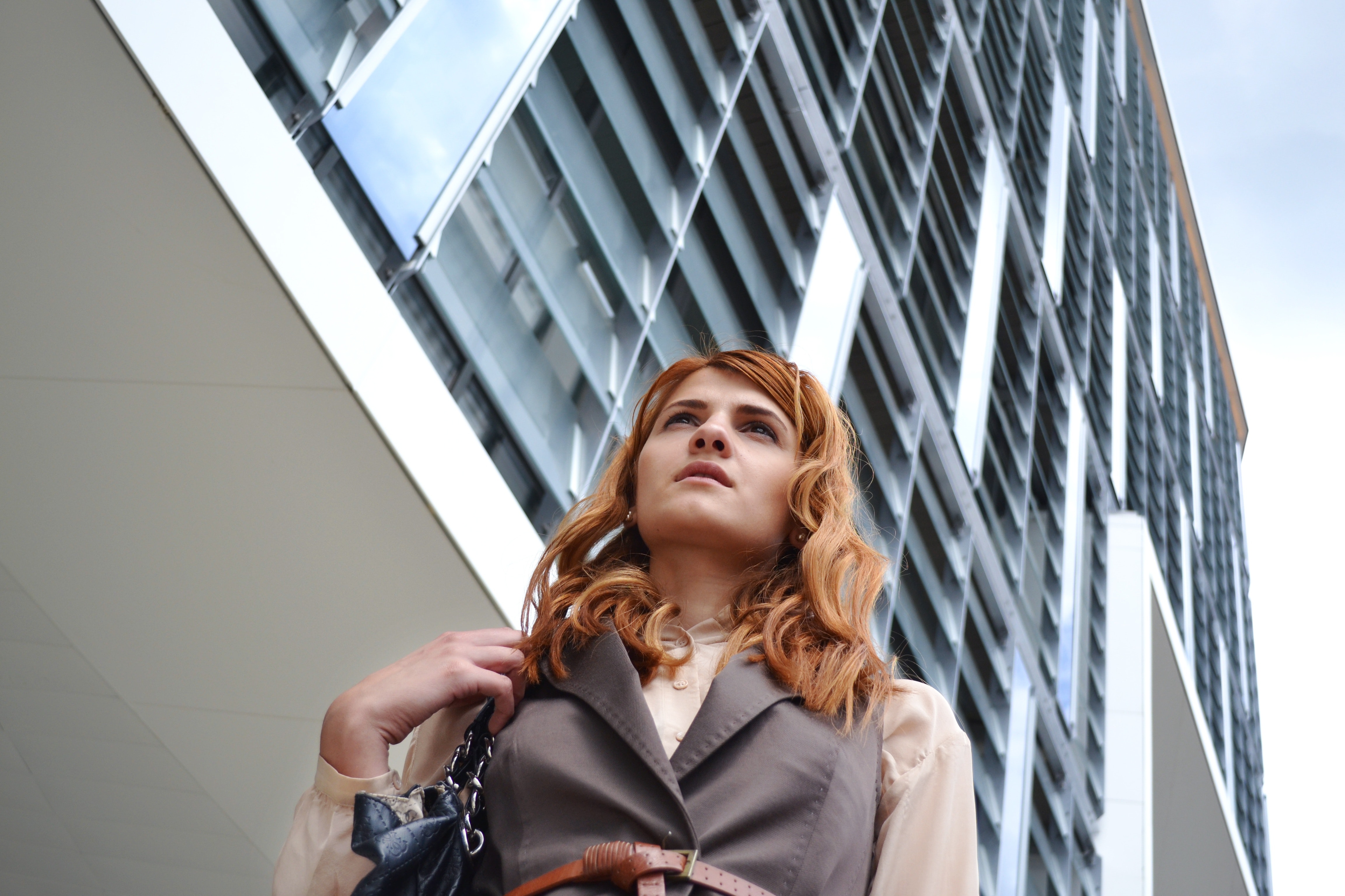 Woman looking at modern office building photo