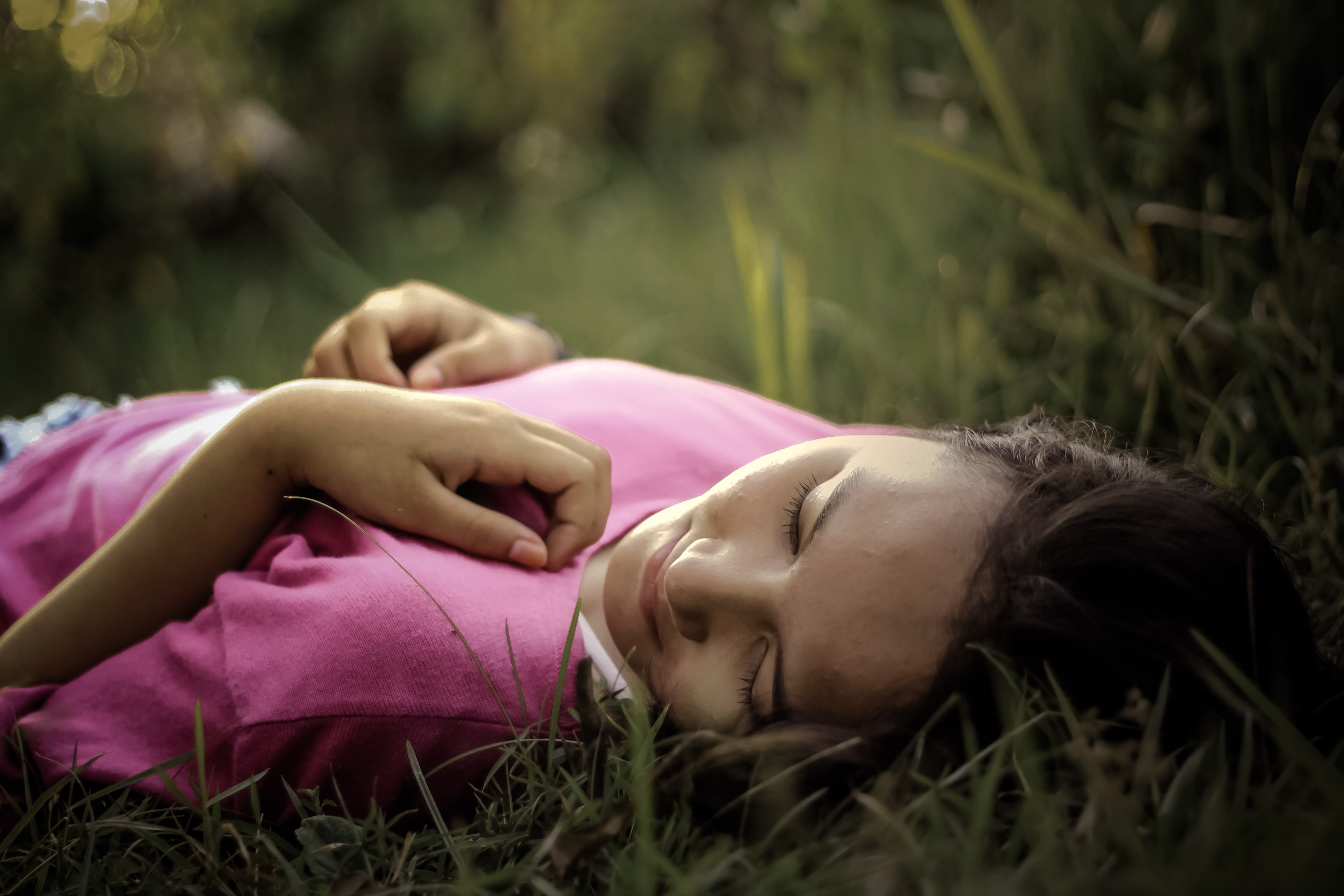 Woman Lying on Green Grass · Free Stock Photo
