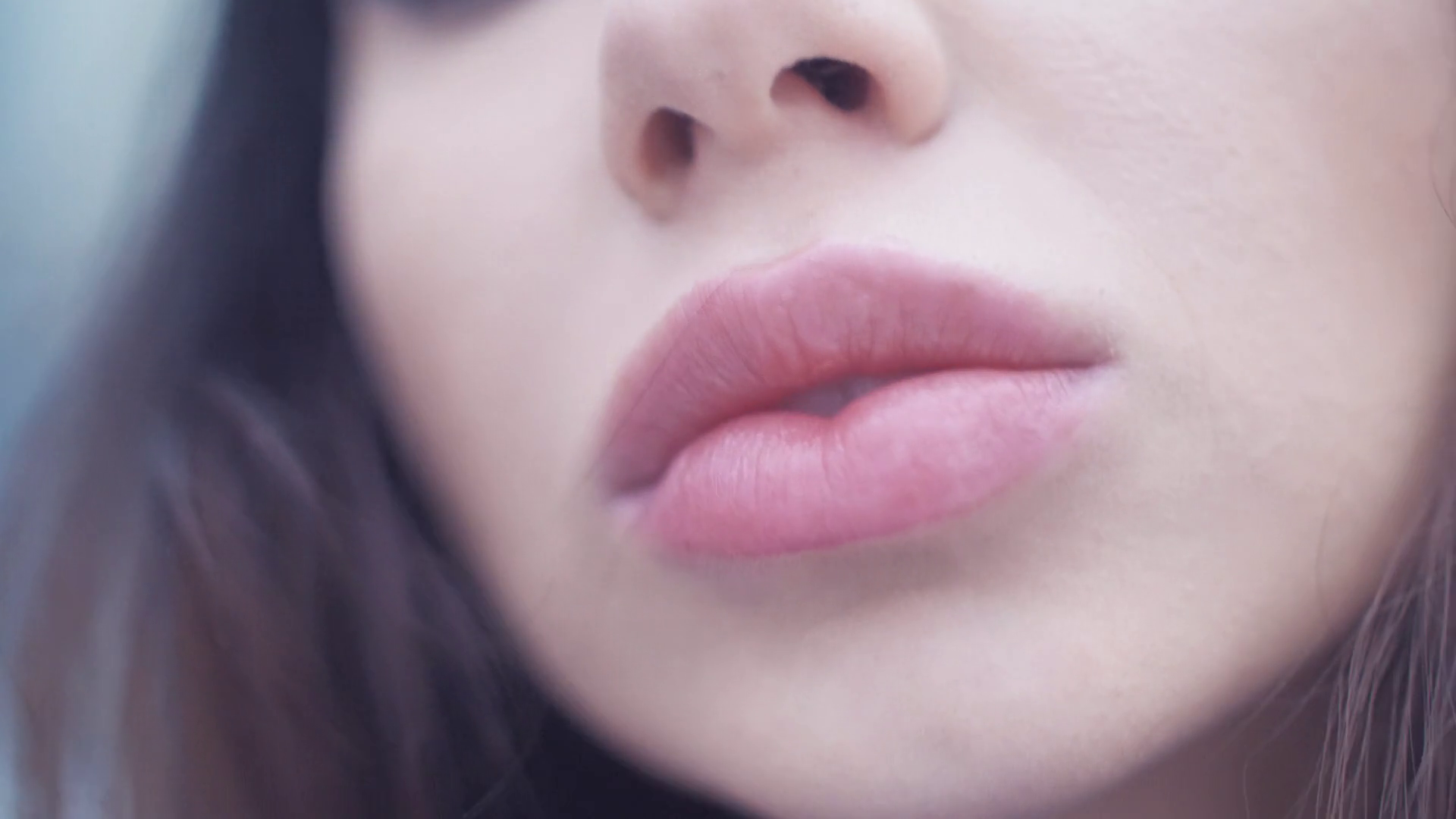 Passionate European woman bites plump pink lips. Extreme Close Up ...