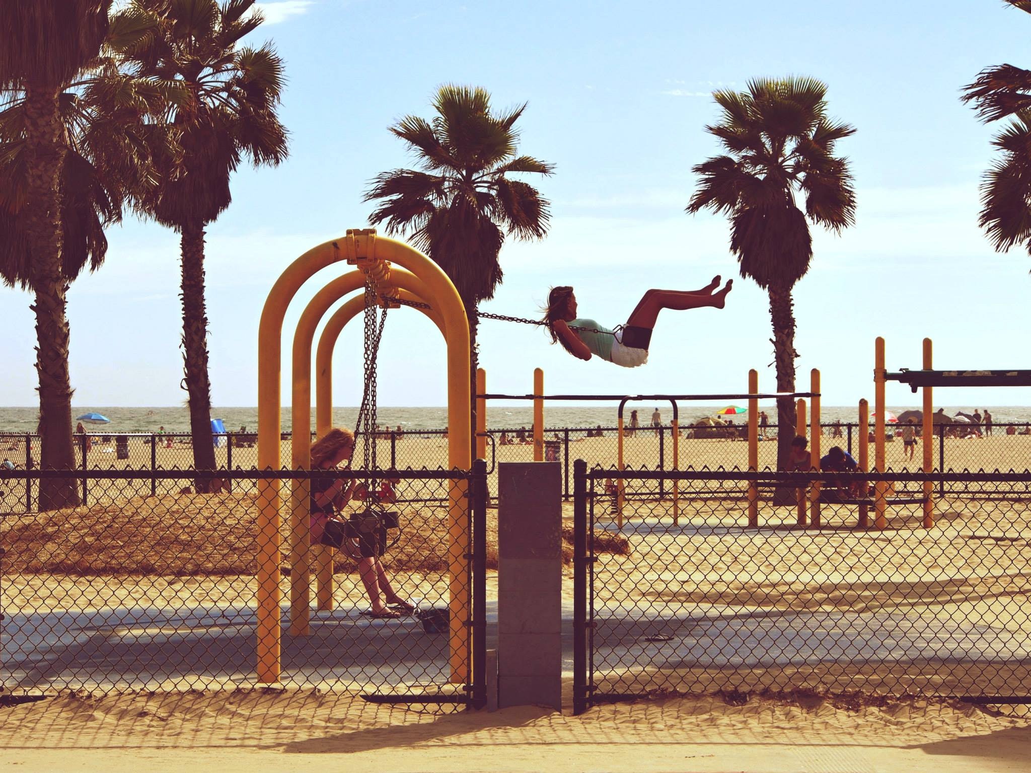 Woman playing swing near beach photo