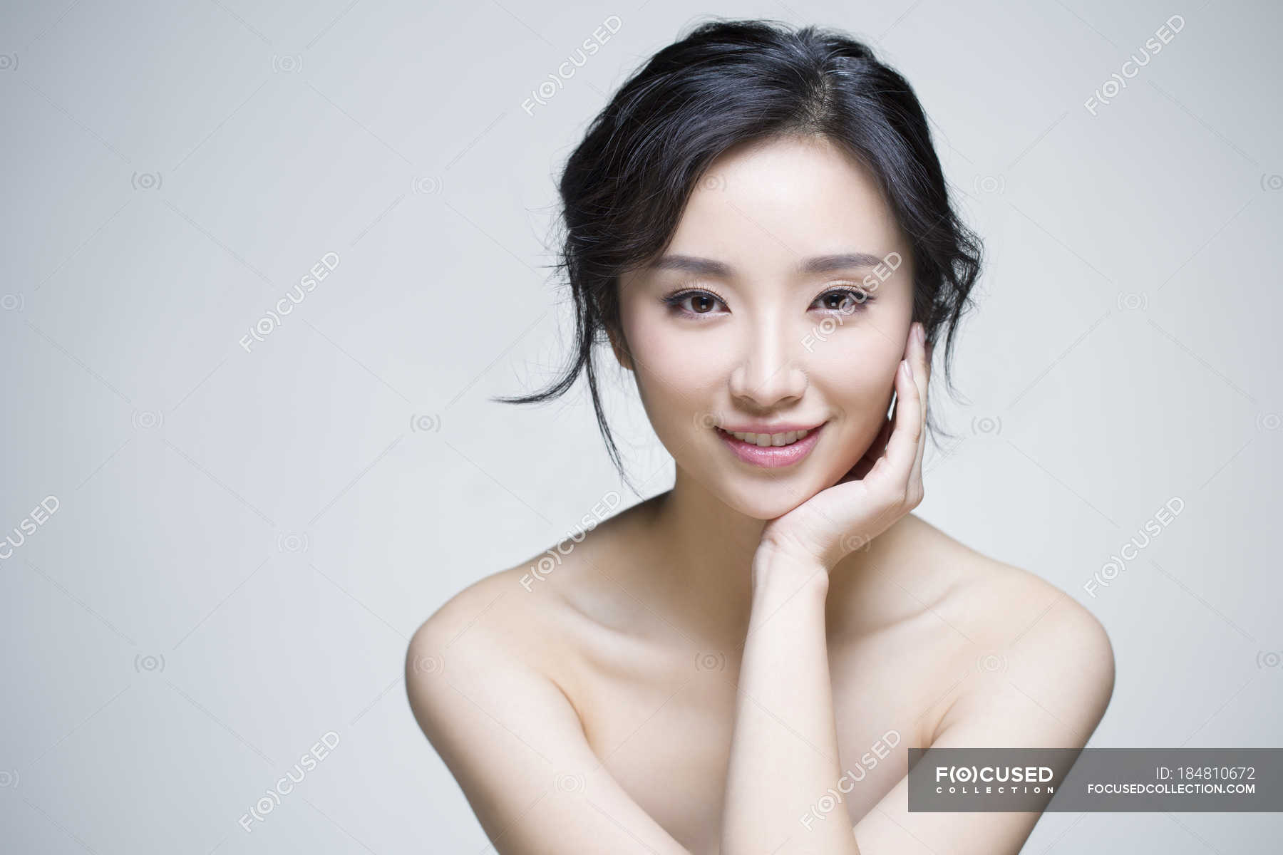 Chinese woman posing with hand on chin — Stock Photo | #184810672
