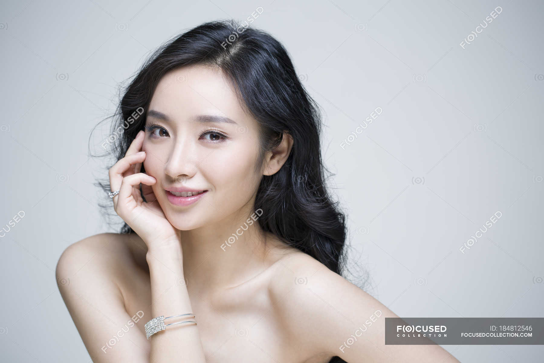 Chinese woman posing with hand on chin — Stock Photo | #184812546