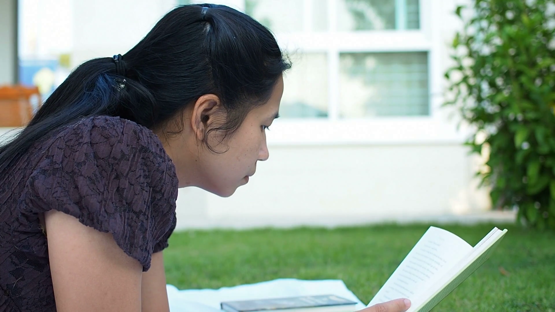 Asian woman reading book outdoor. Stock Video Footage - Videoblocks