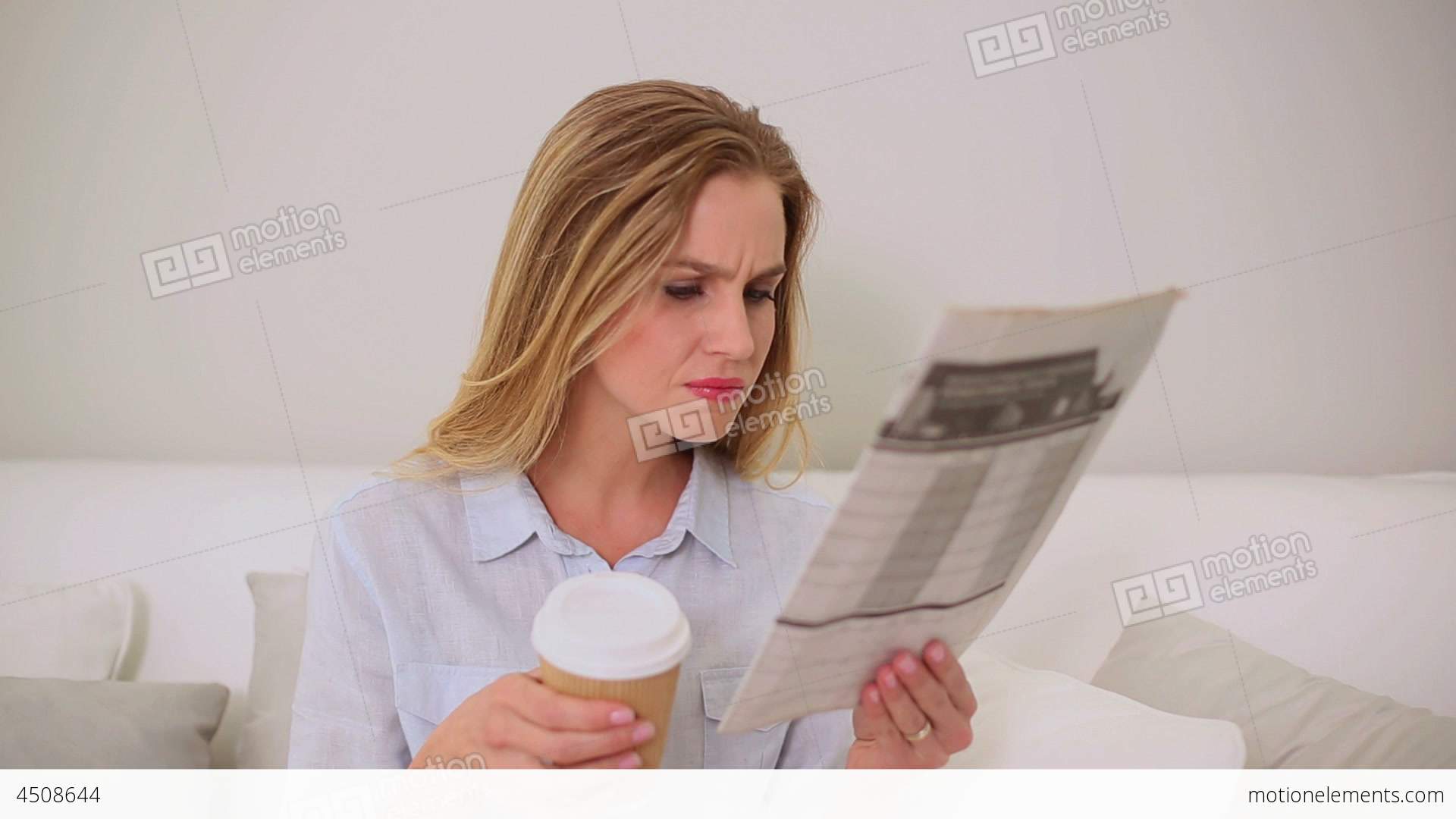 Calm Blonde Woman Reading Newspaper Sitting On Cou Stock video ...