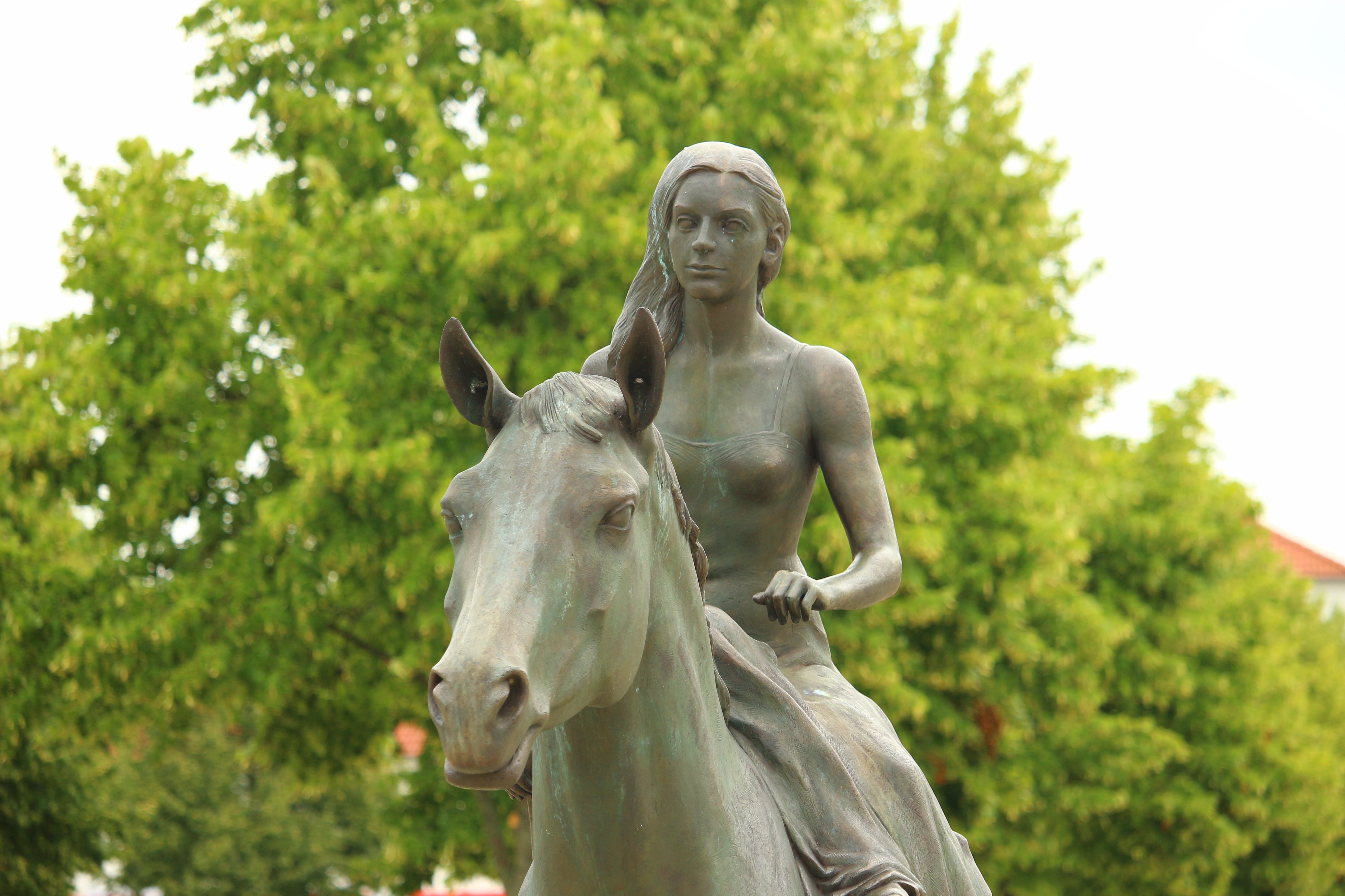 Woman riding horse statue photo