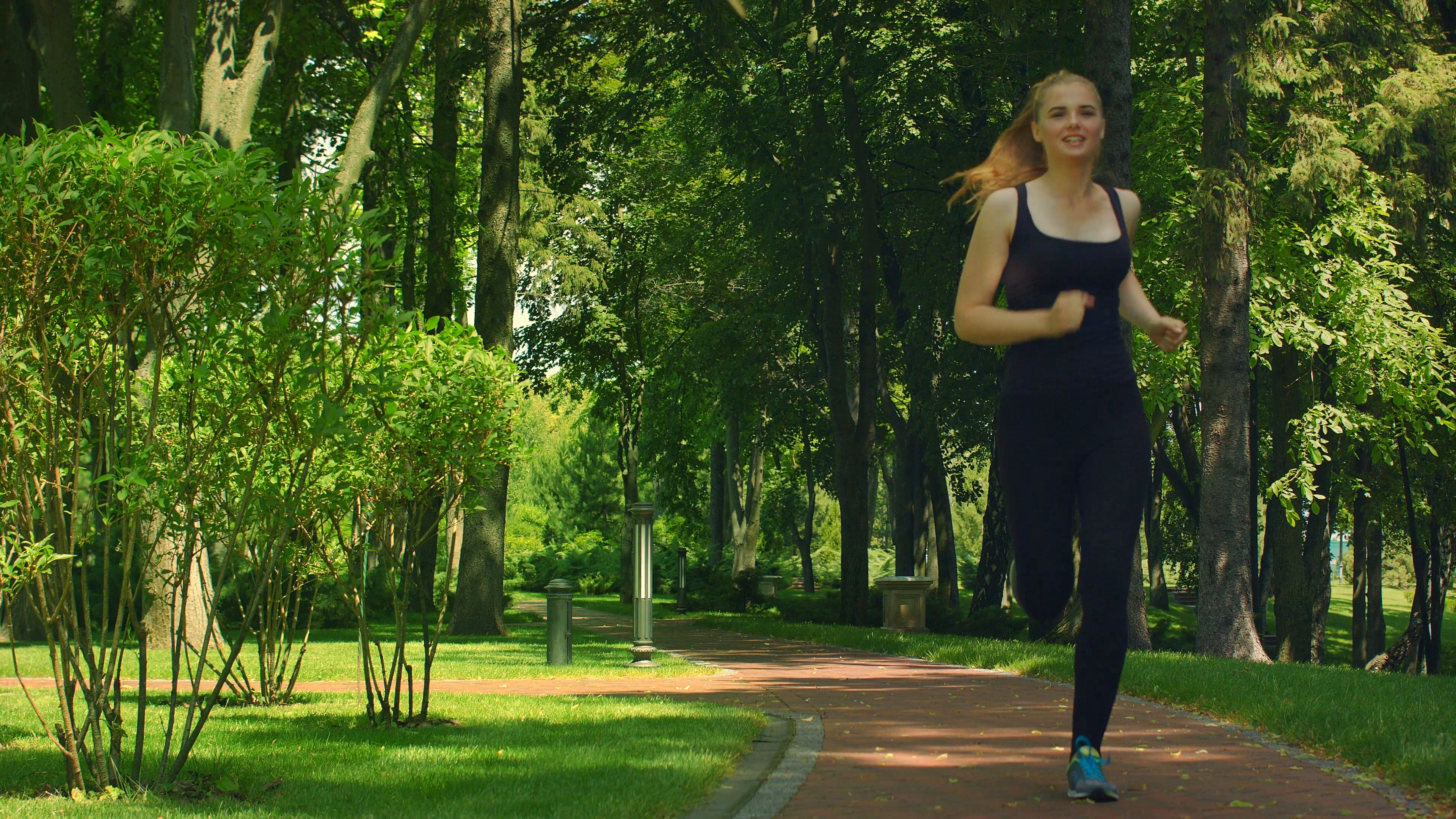 Woman running in park in slow motion. Fitness woman jogging. Female ...