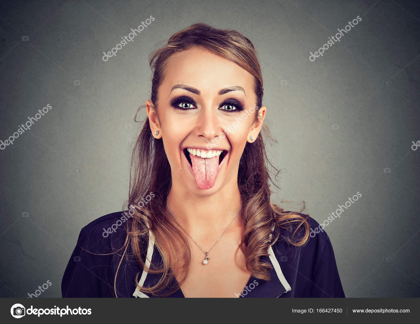 portrait of a young funny looking woman showing her tongue — Stock ...