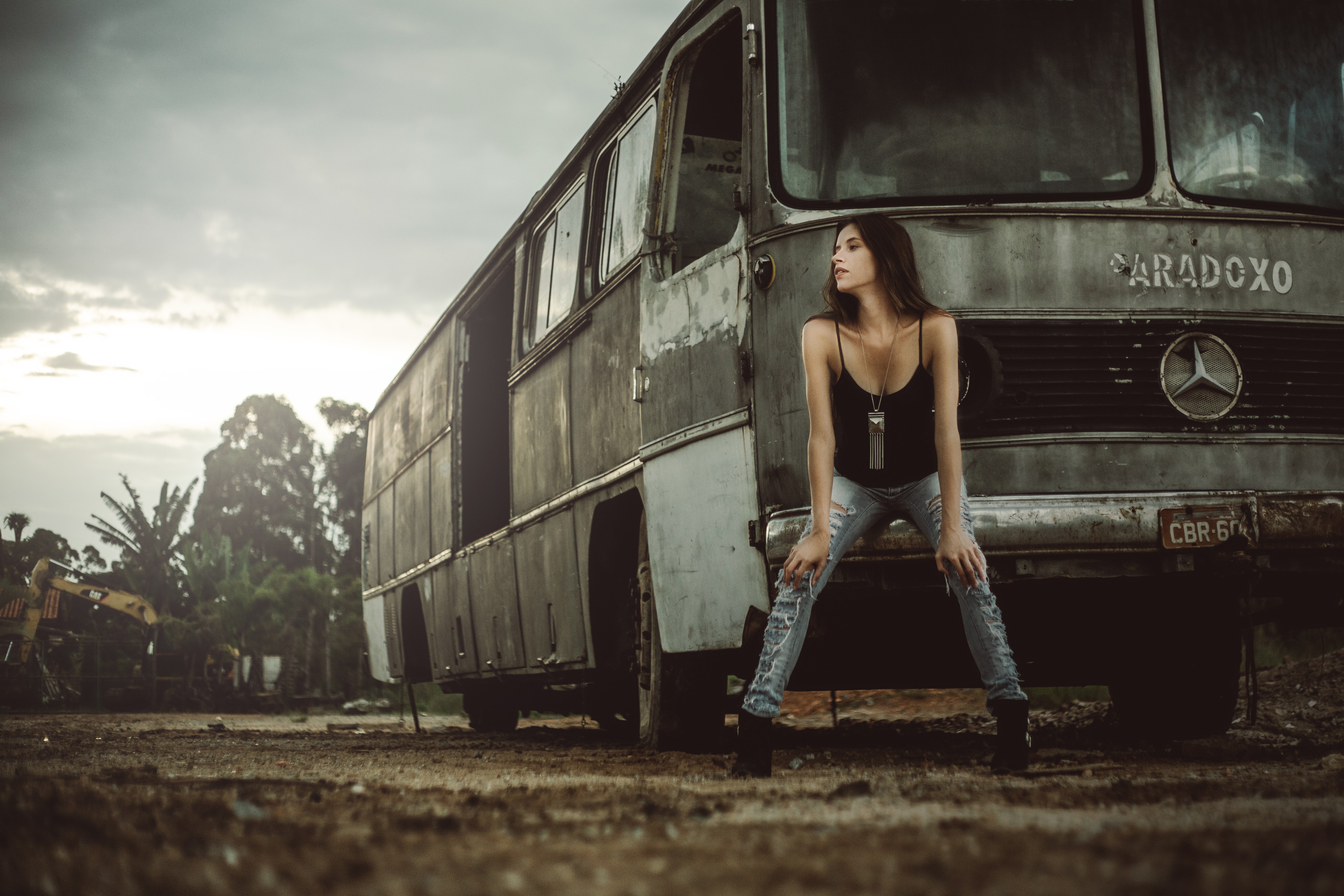 Woman sitting in front of bus photo