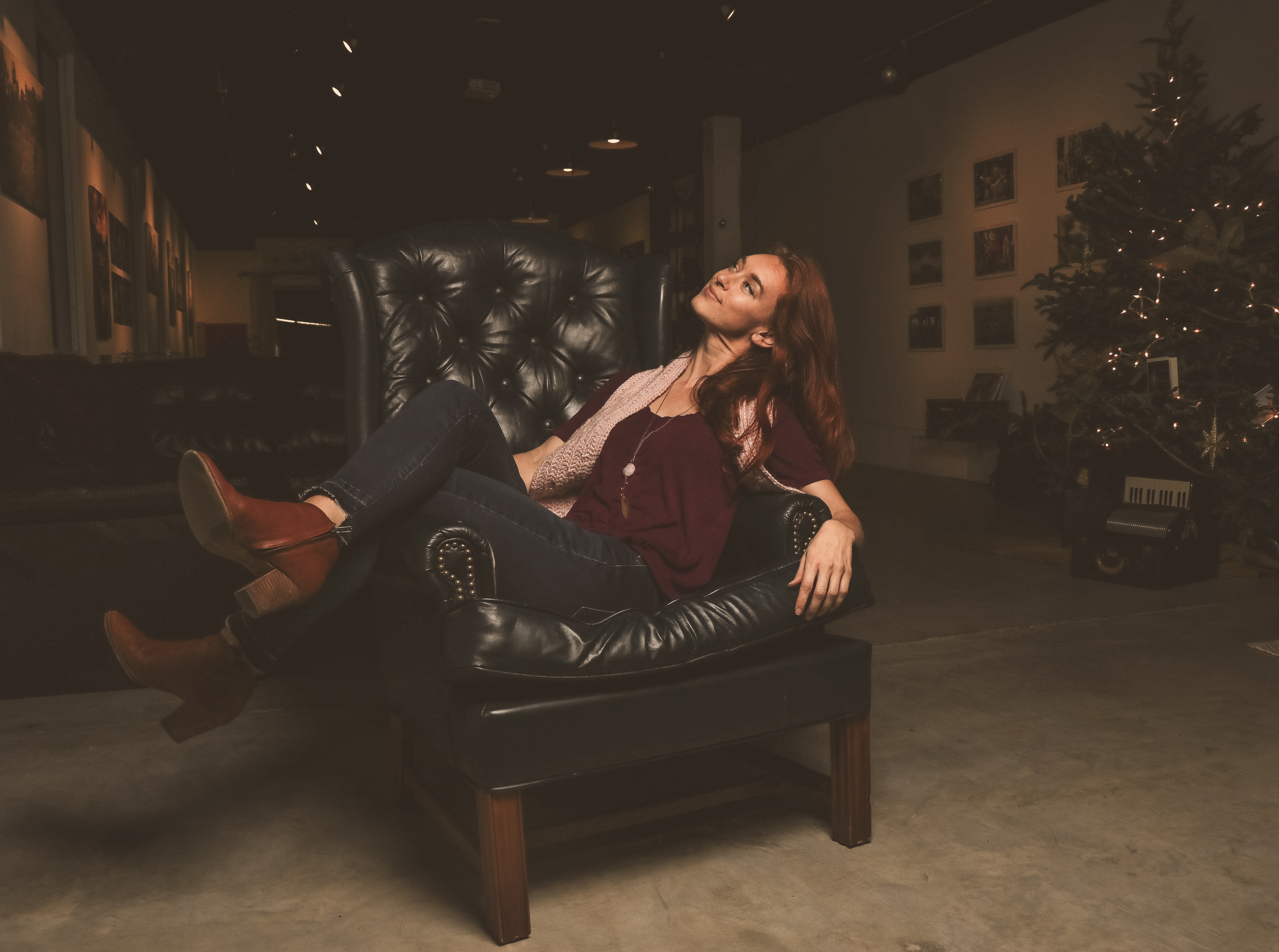 Woman sitting on black leather armchair photo