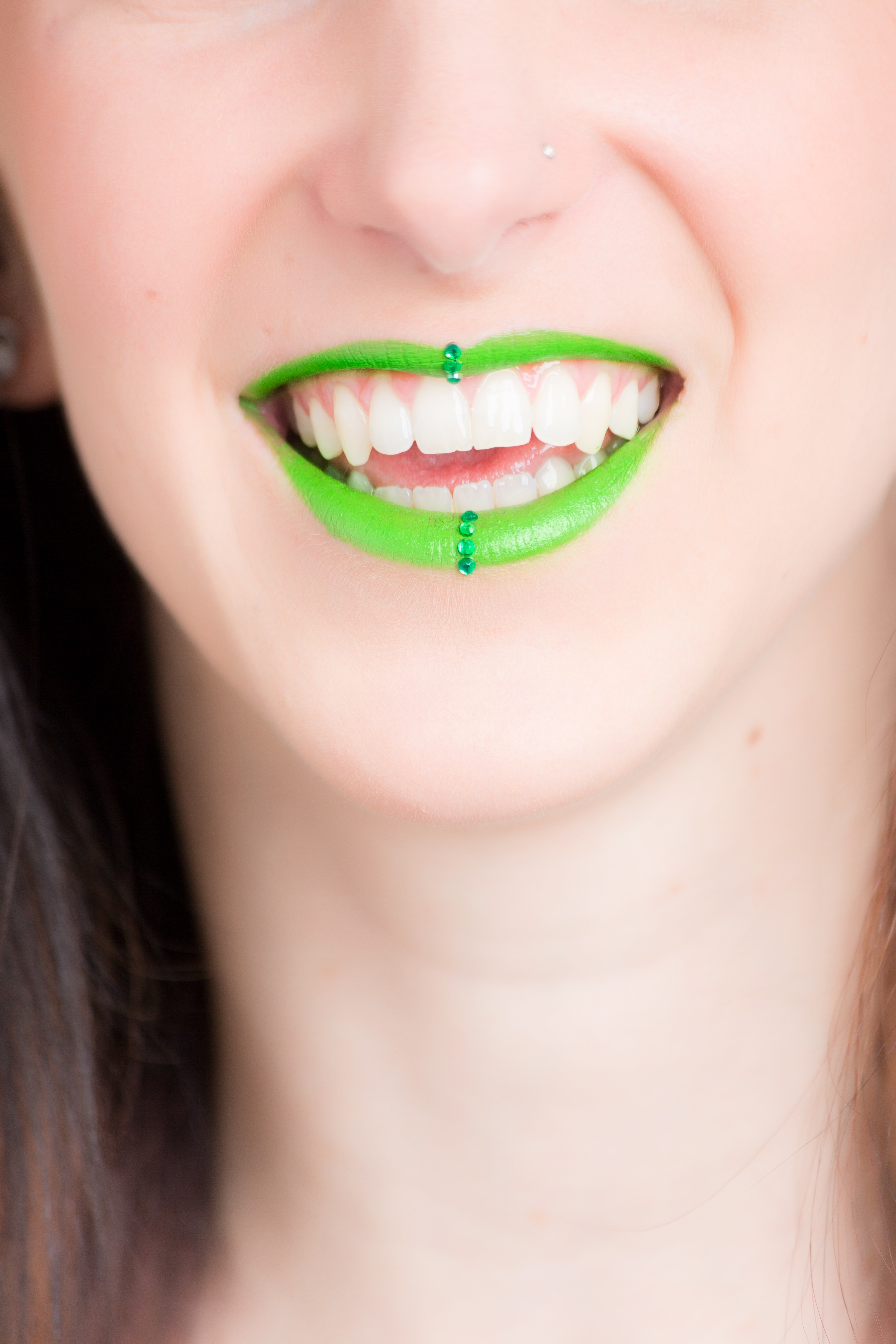 Woman smiling with green lipstick photo