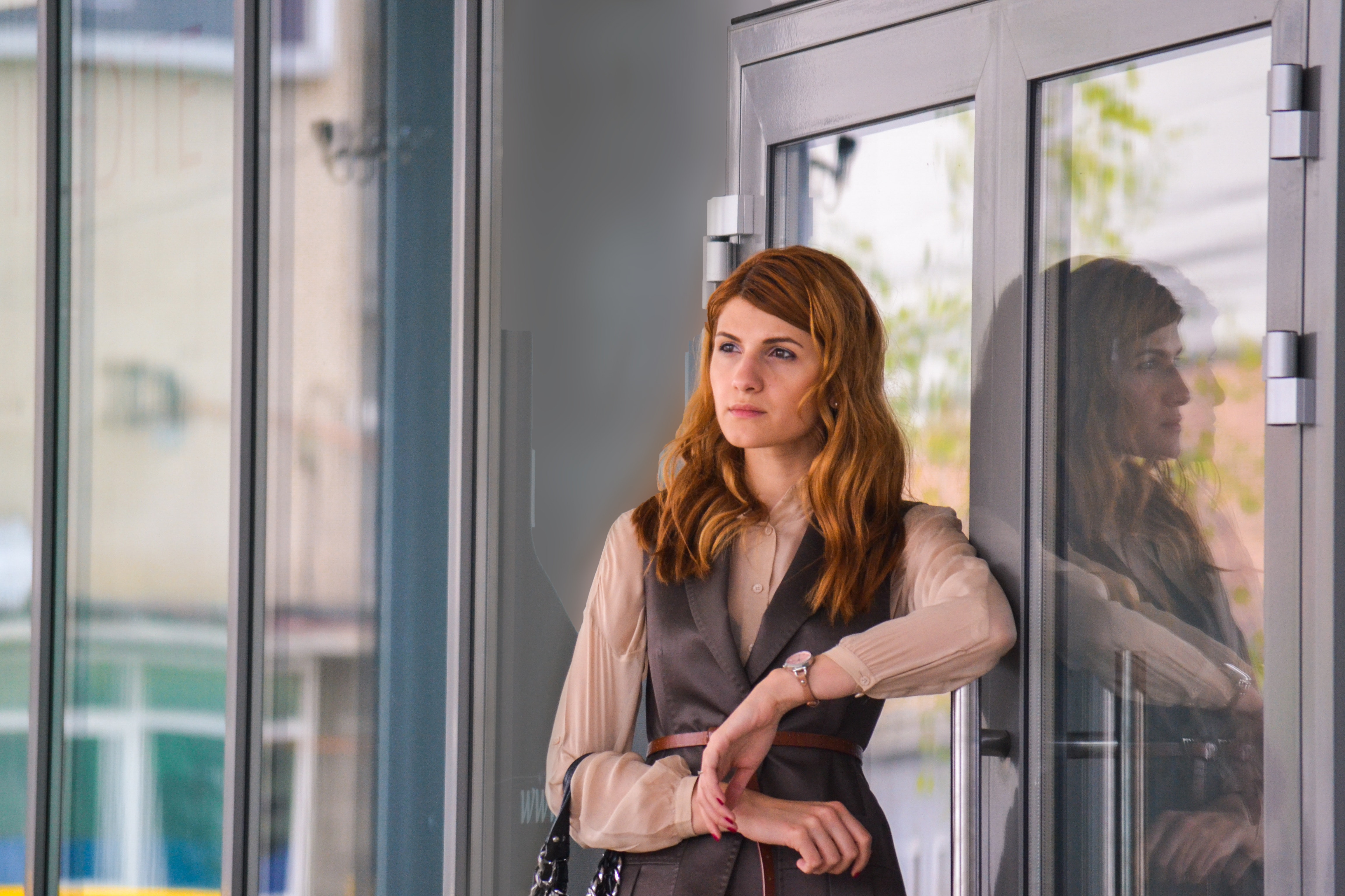 Woman standing near clear glass gray framed door panel photo