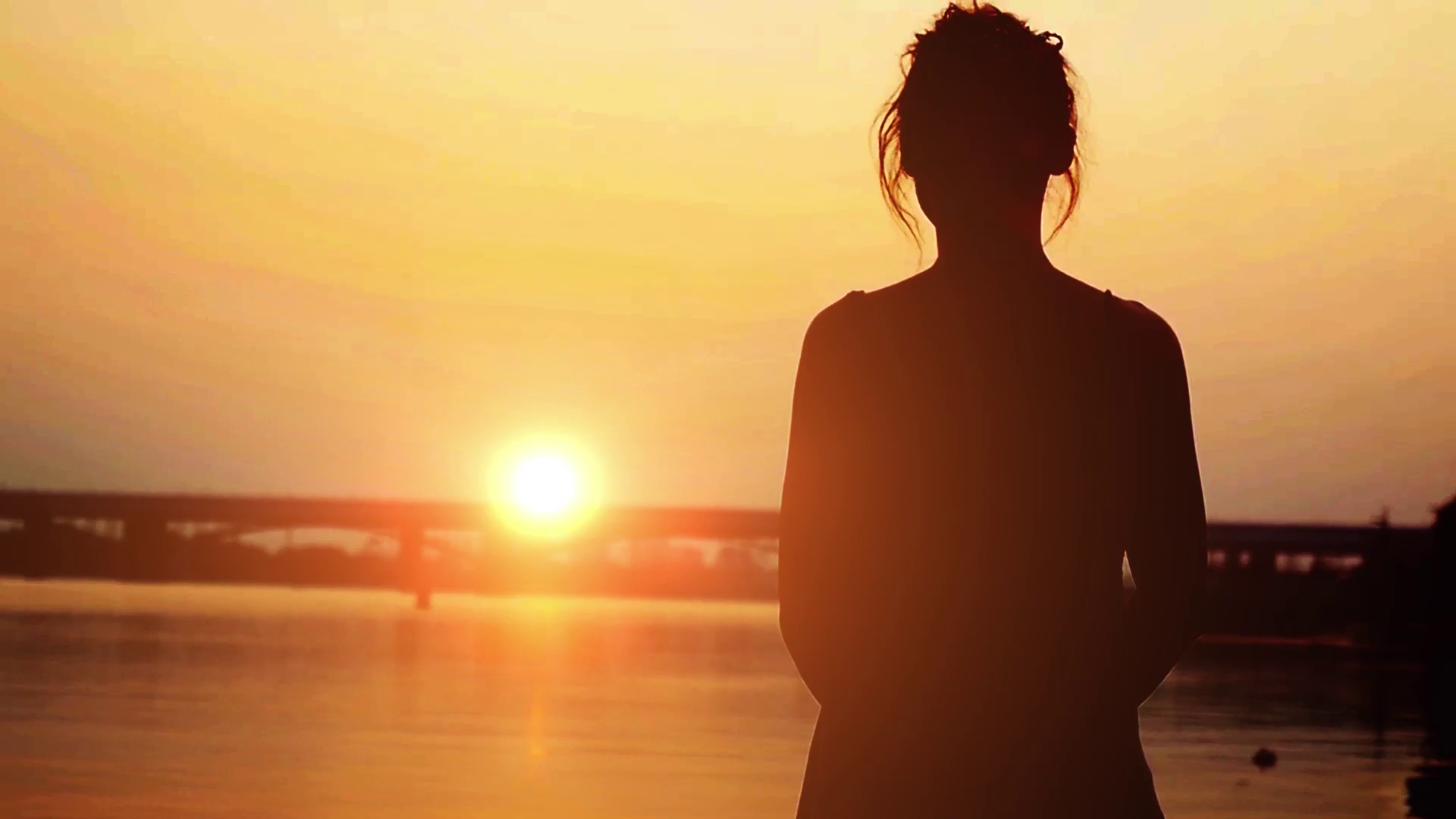 Silhouette of beautiful woman standing on sandy beach, watching sun ...
