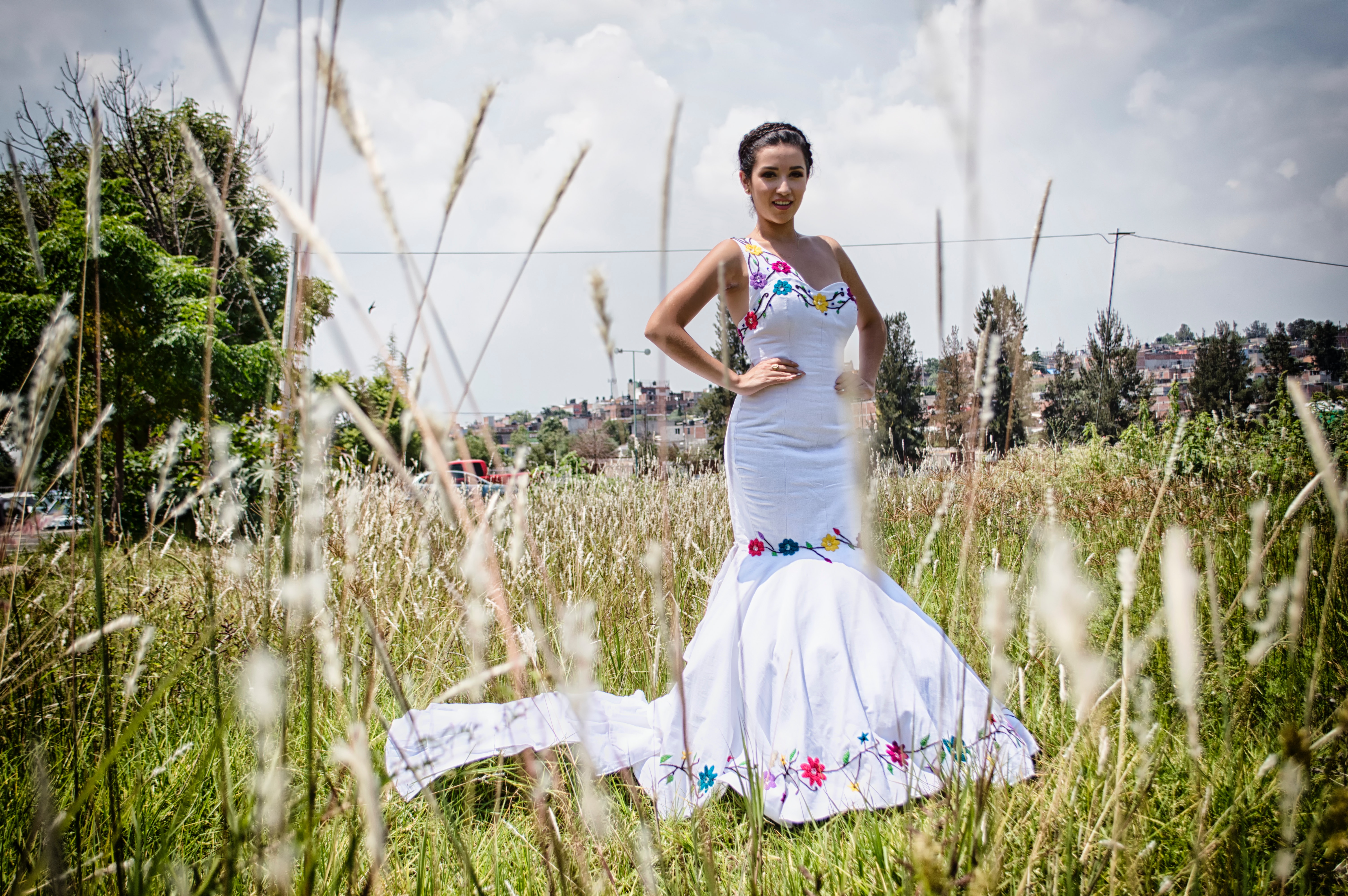 Woman standing on grass field wearing mermaid dress photo