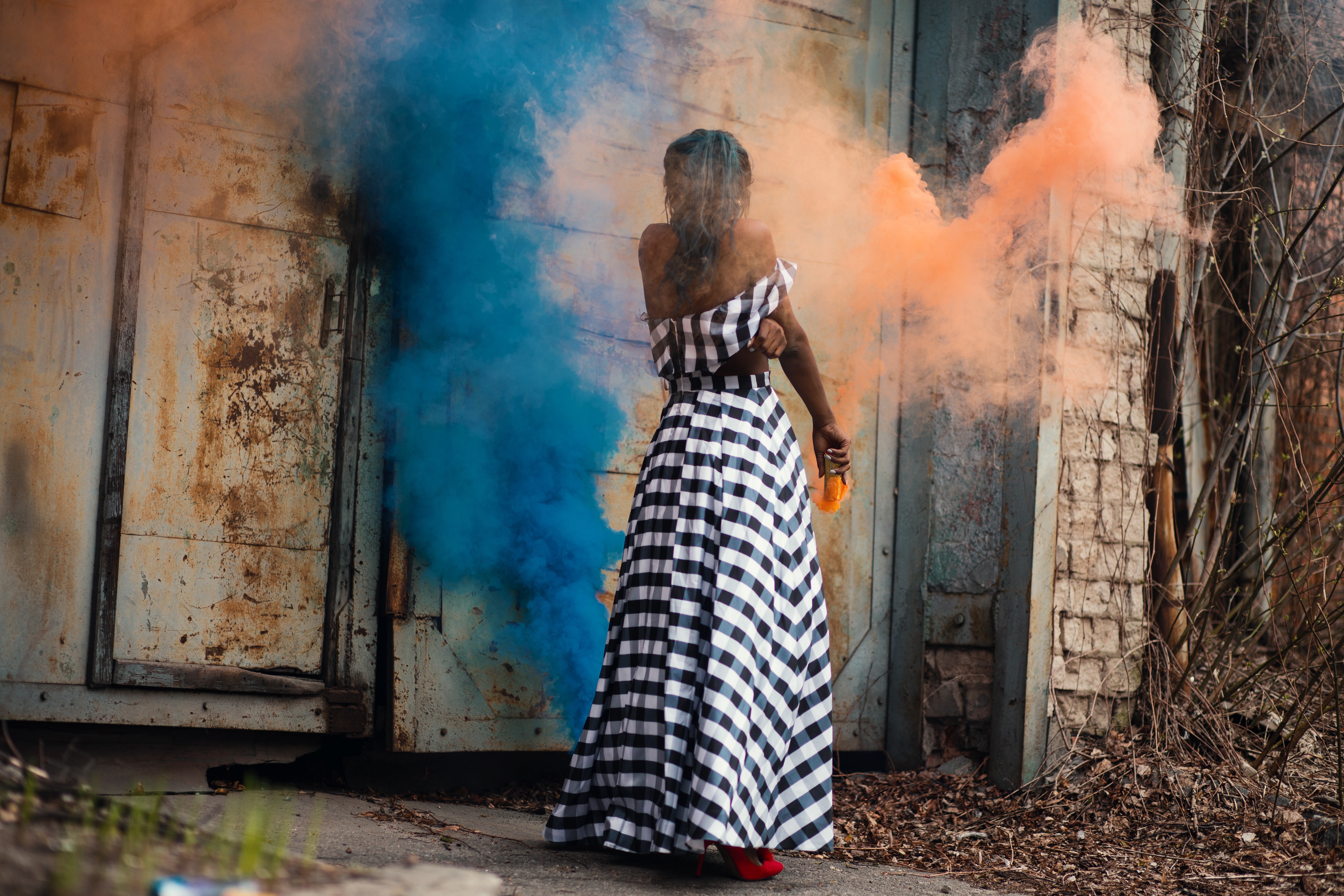 Woman standing on orange and blue smoke photo