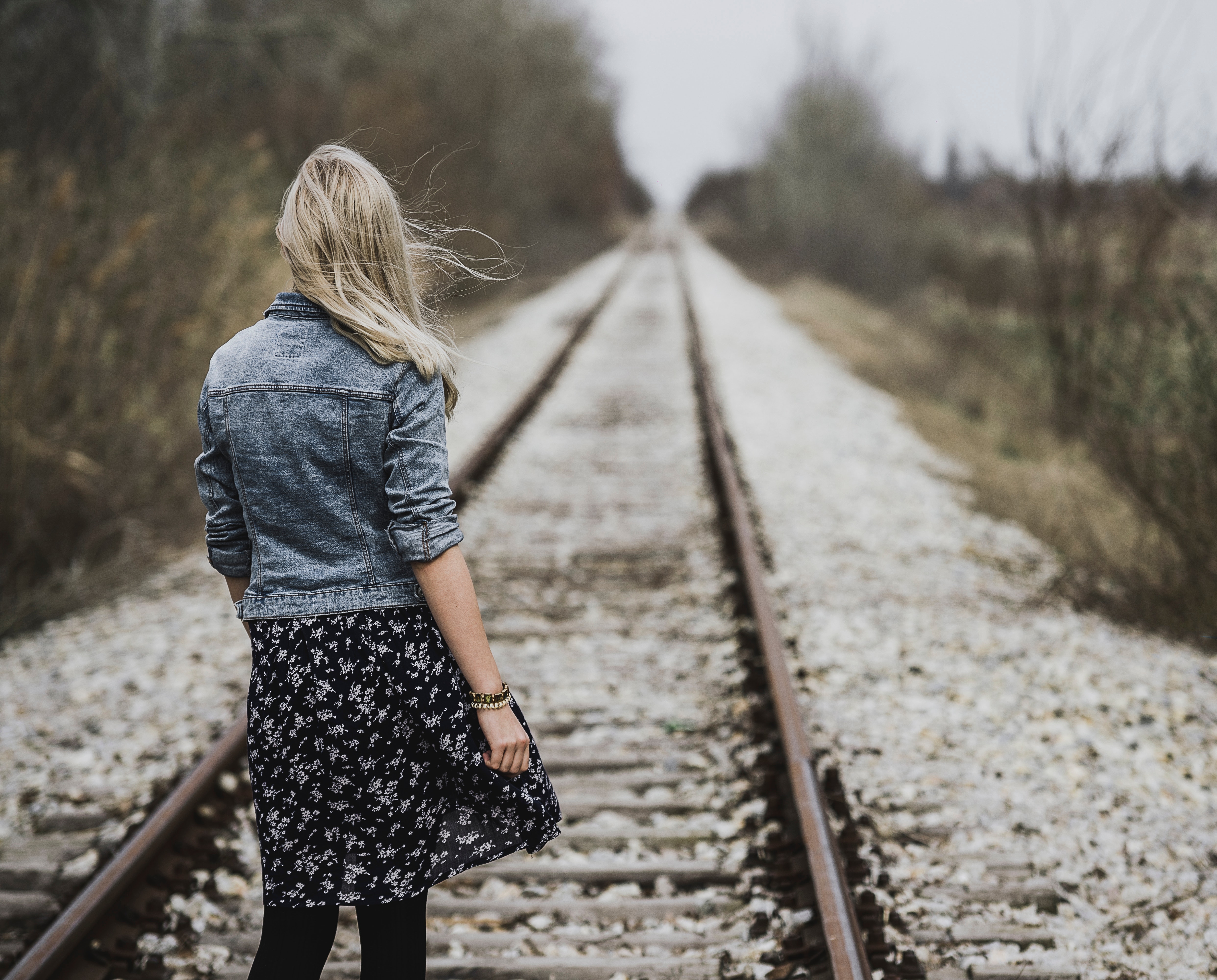 Woman standing on railroad photo