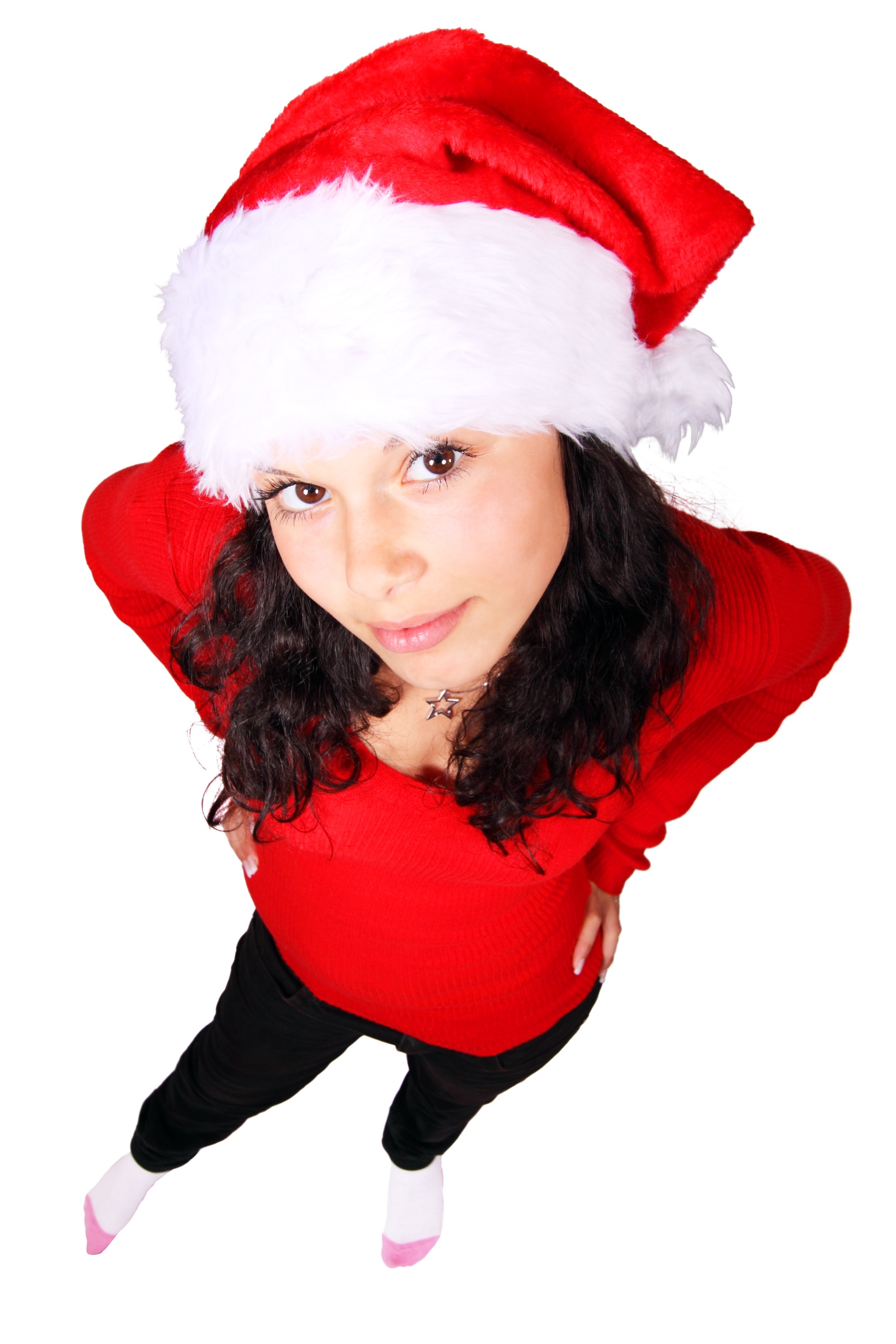 Woman standing wearing red scoop neck long sleeve shirt and santa cap photo