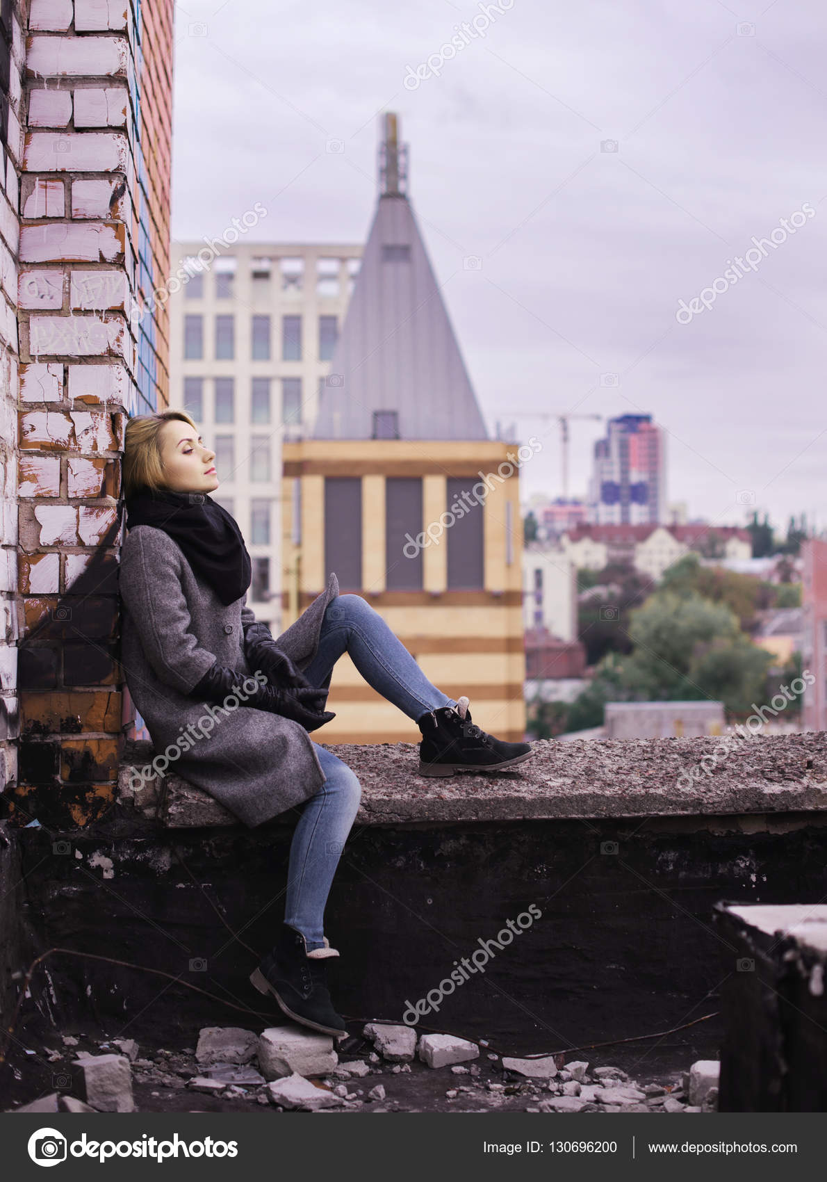 Business woman sitting on building rooftop. Suicide concept imag ...