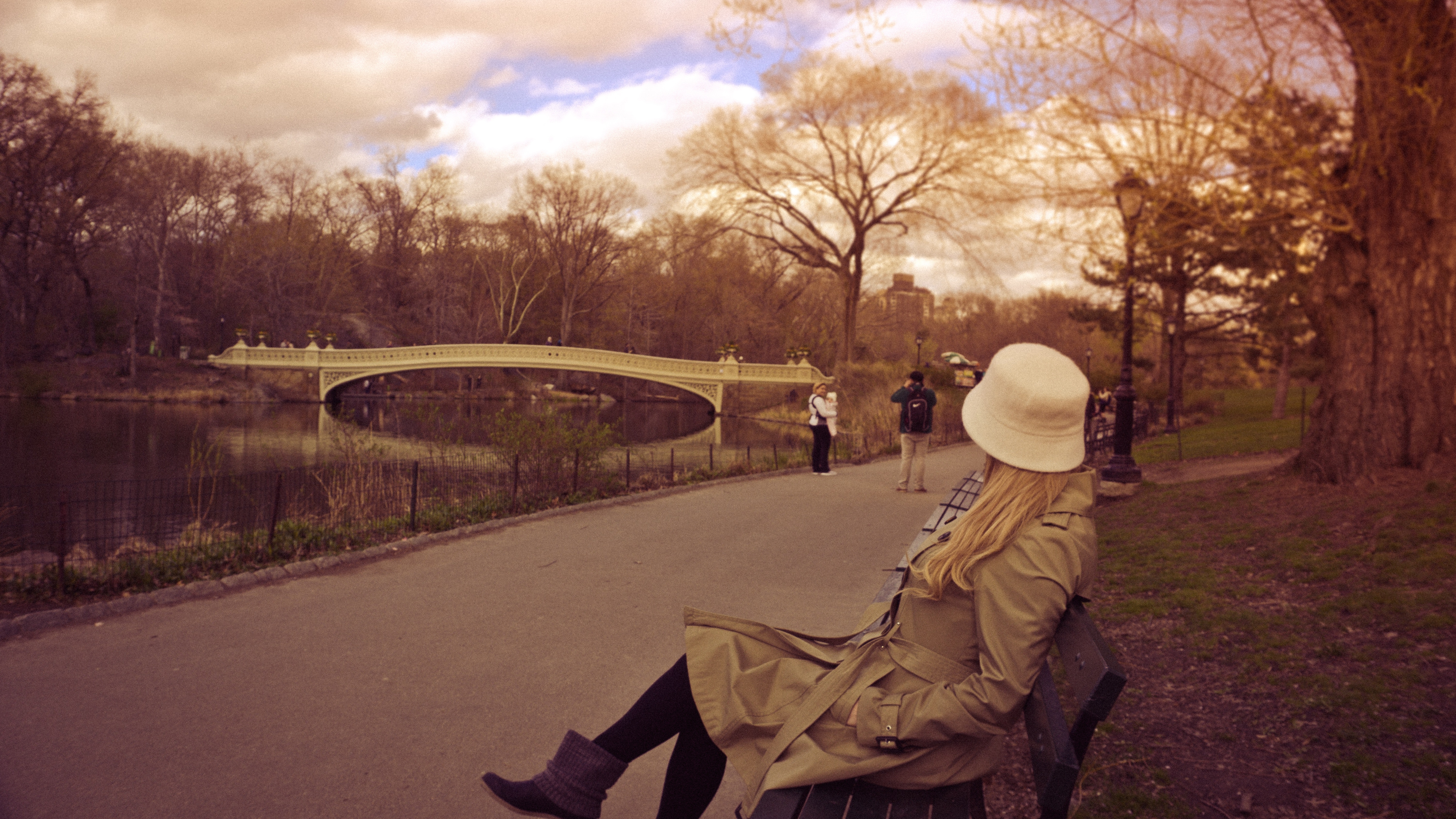 Woman in White Bucket Hat, Brown Coat and Boots Sitting on Bench at ...