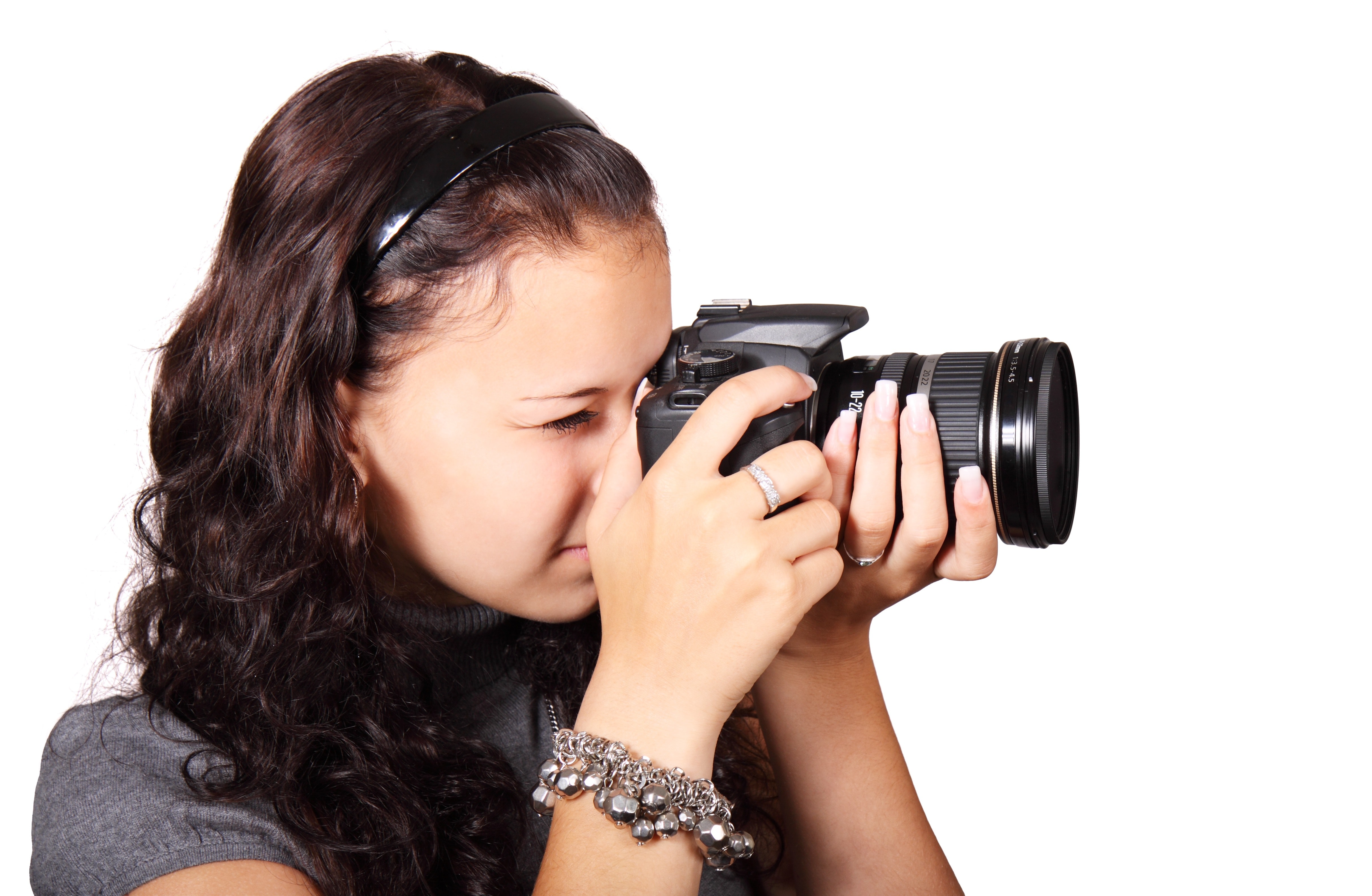 Woman taking picture with her black dslr camera photo
