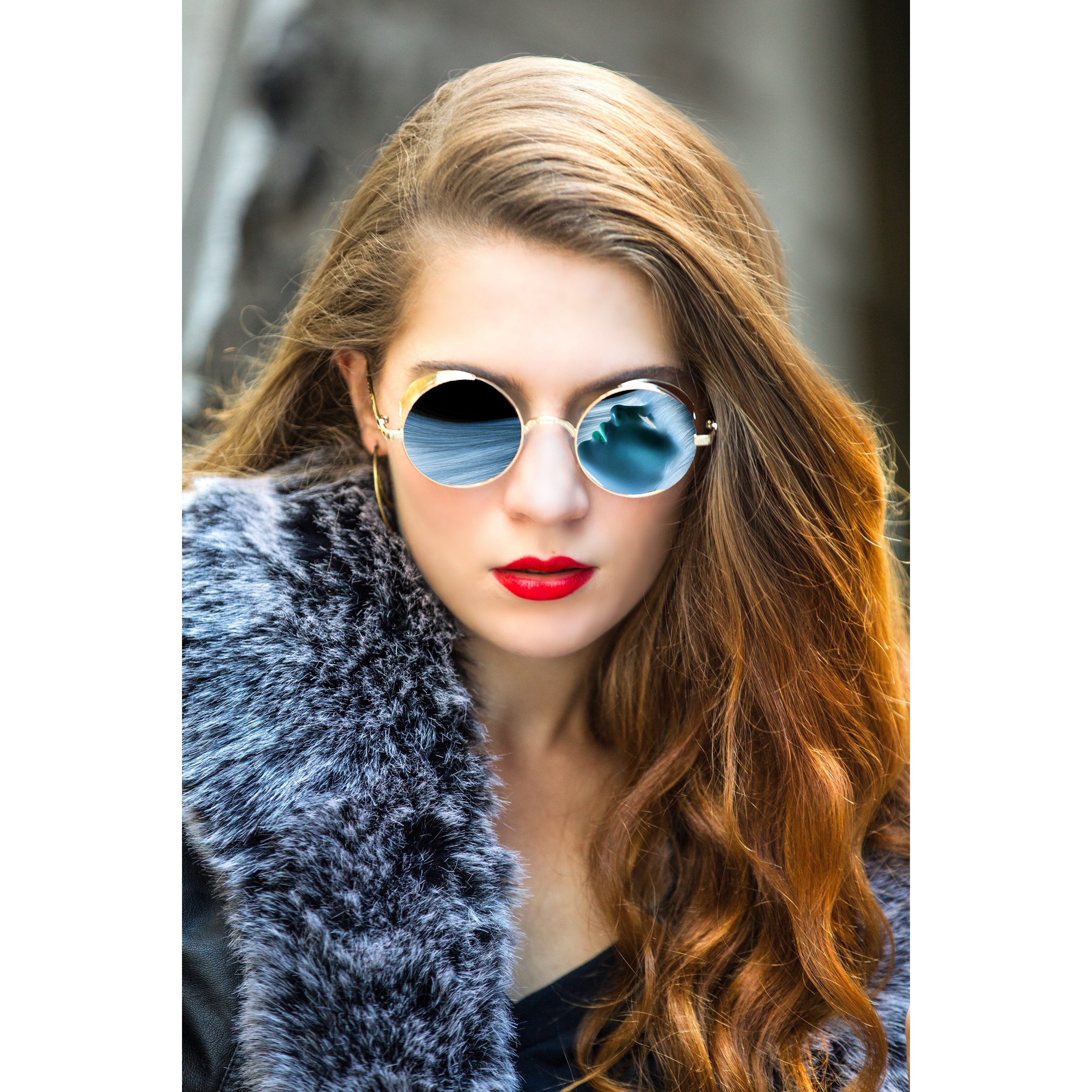 Woman taking selfie wearing round blue sunglasses photo