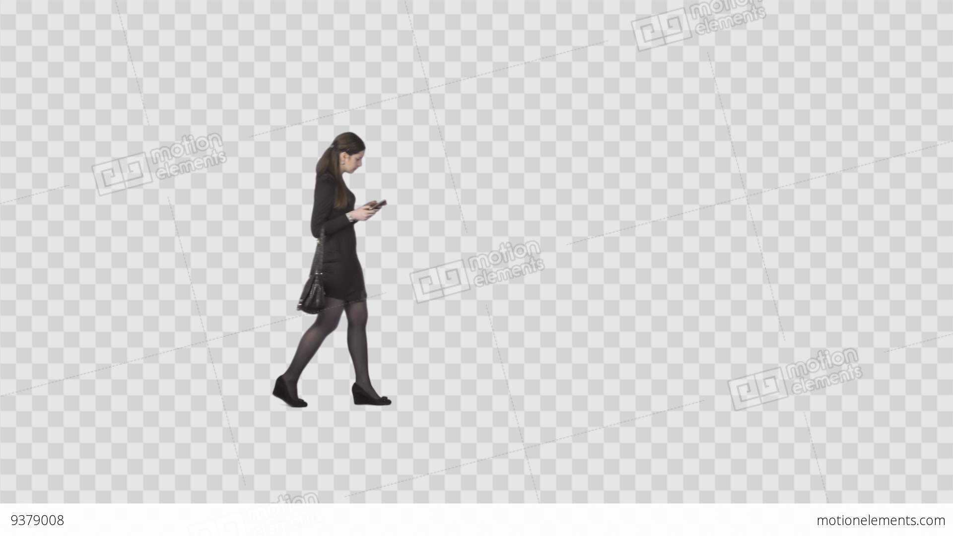 Elegant Young Woman Walking And Looking At Cell Phone. Alpha Channel ...