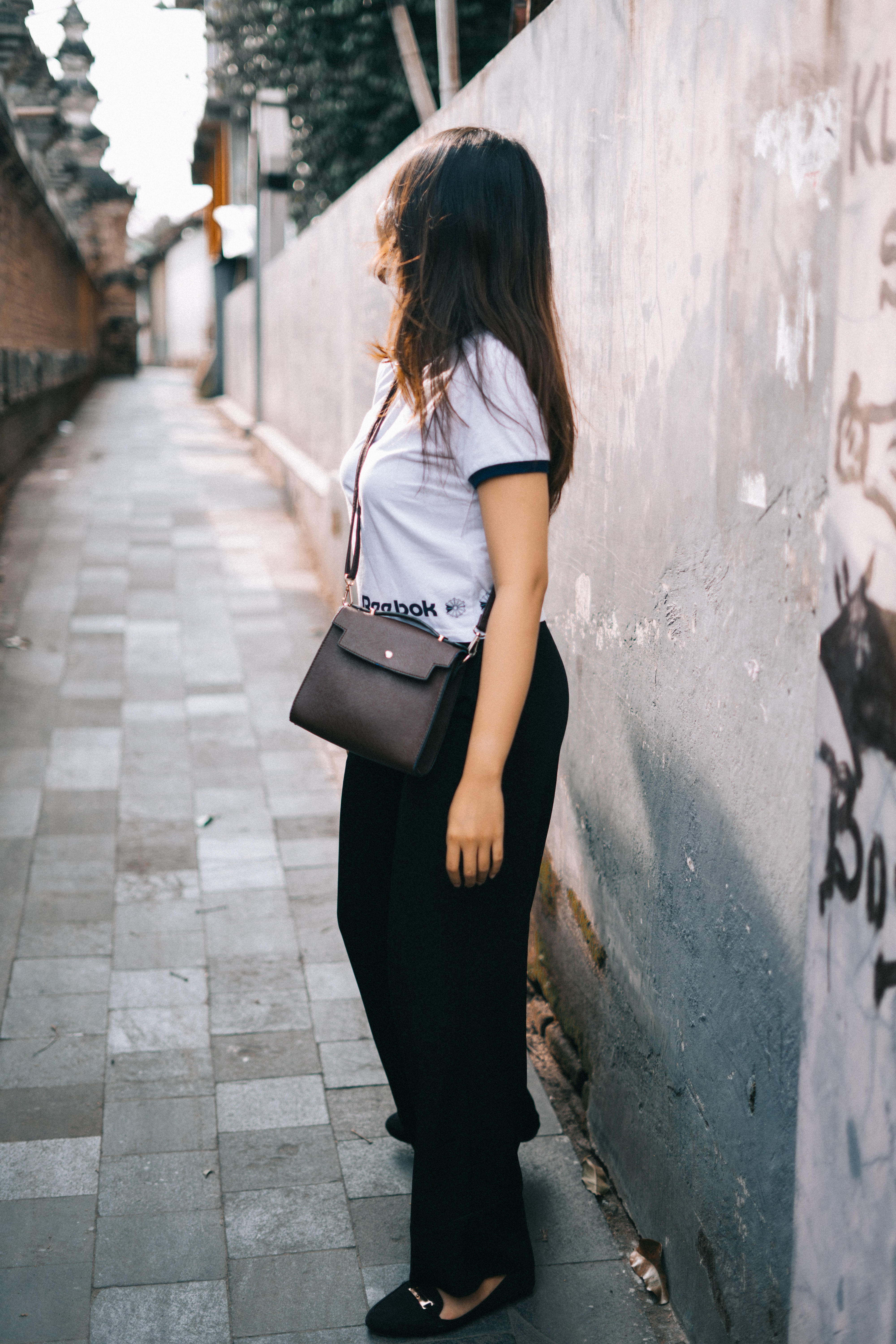 Woman wearing black and white t-shirt and black pants photo