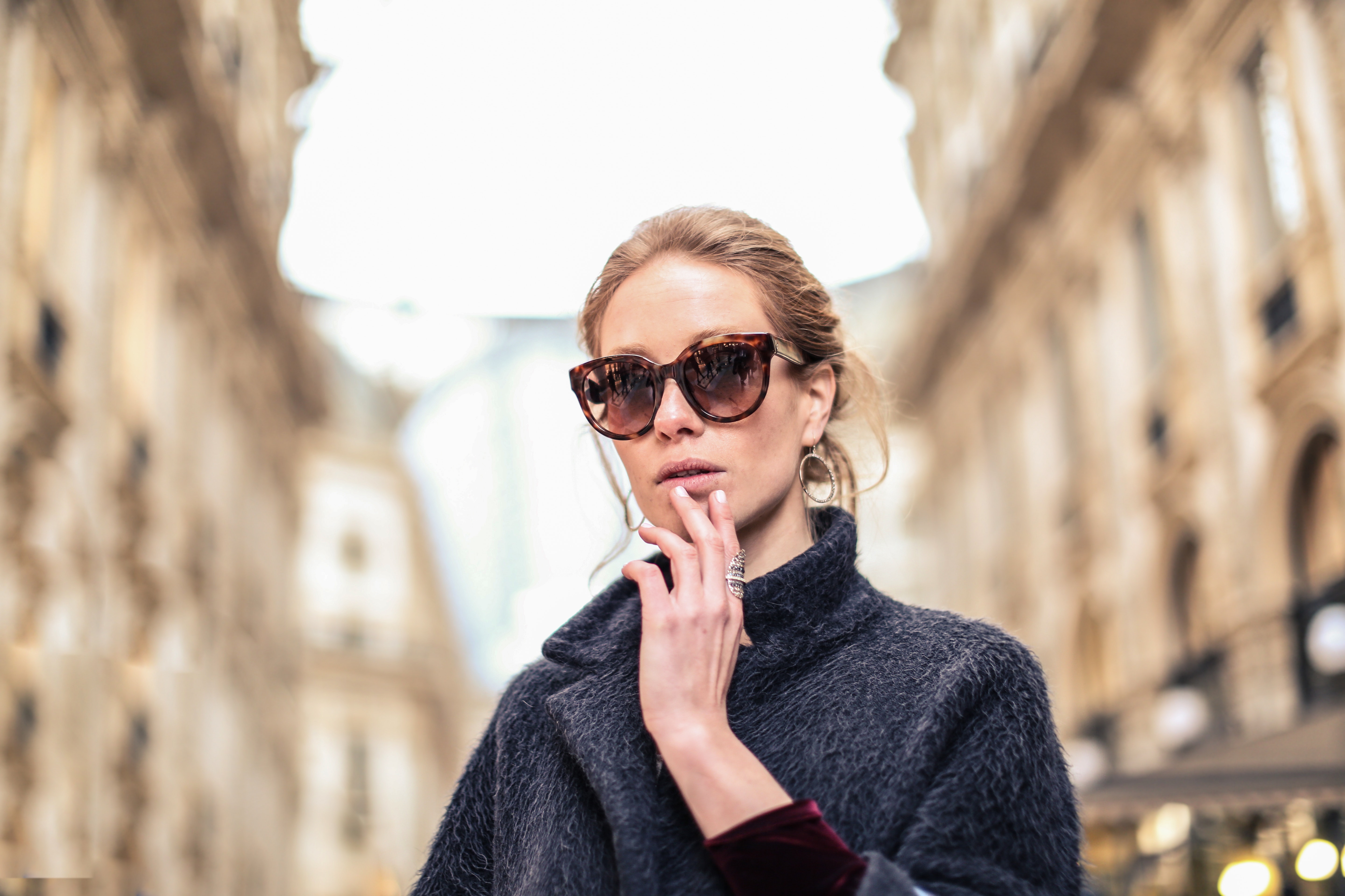 Woman wearing black coat and brown framed sunglasses photo